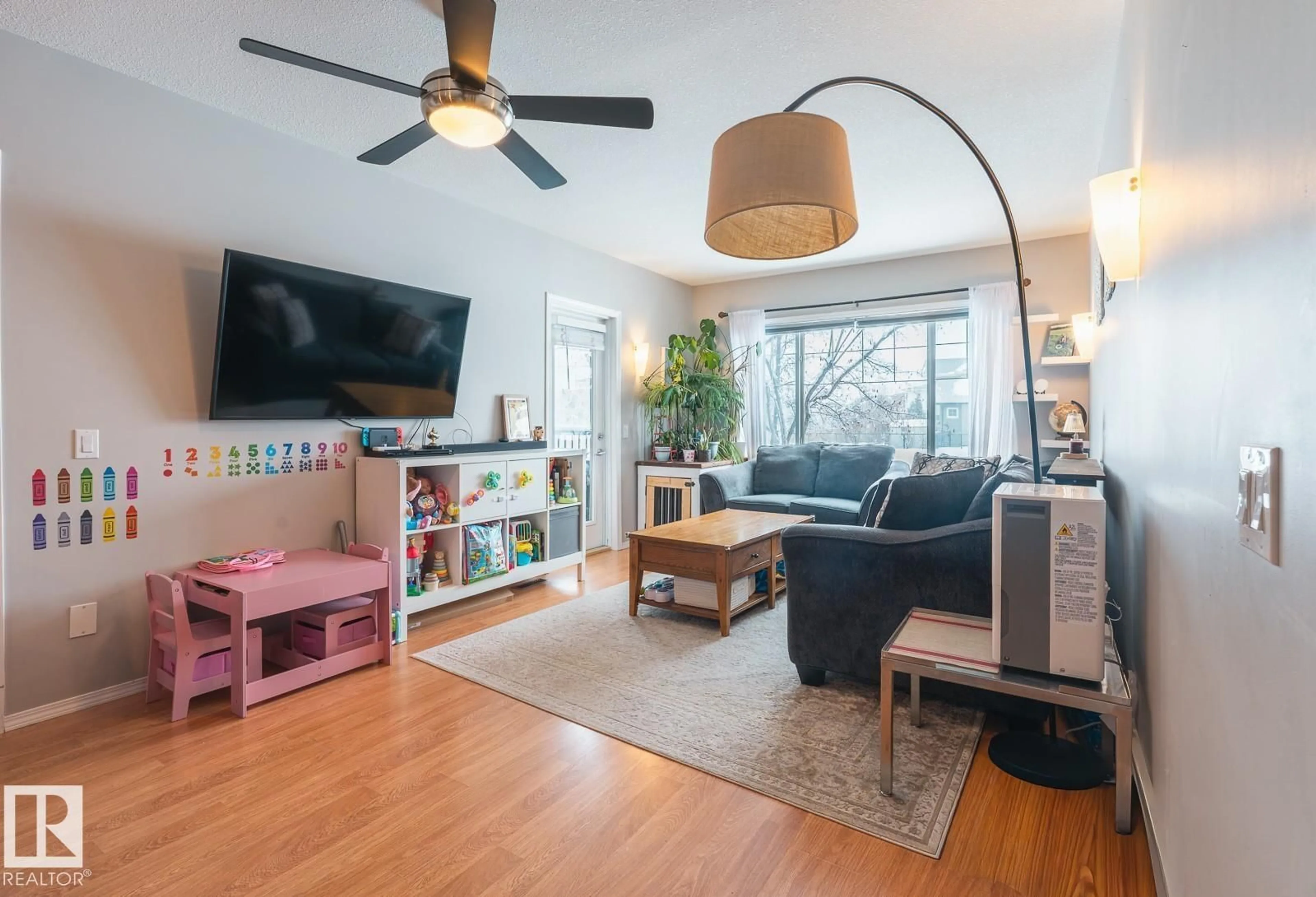 Living room with furniture, wood/laminate floor for 671 - 9 SILVER BERRY RD, Edmonton Alberta T6T0B7