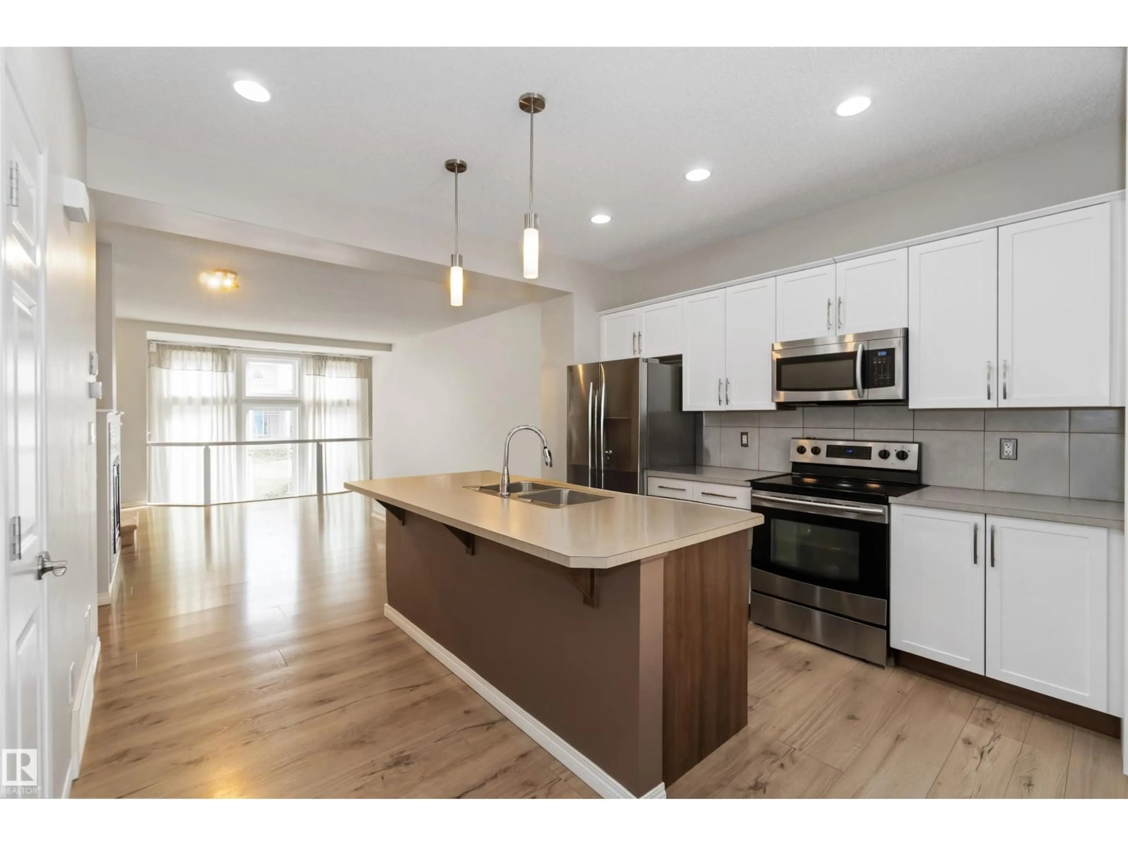 Open concept kitchen, wood/laminate floor for NW - 9932 221 ST, Edmonton Alberta T5T4M7