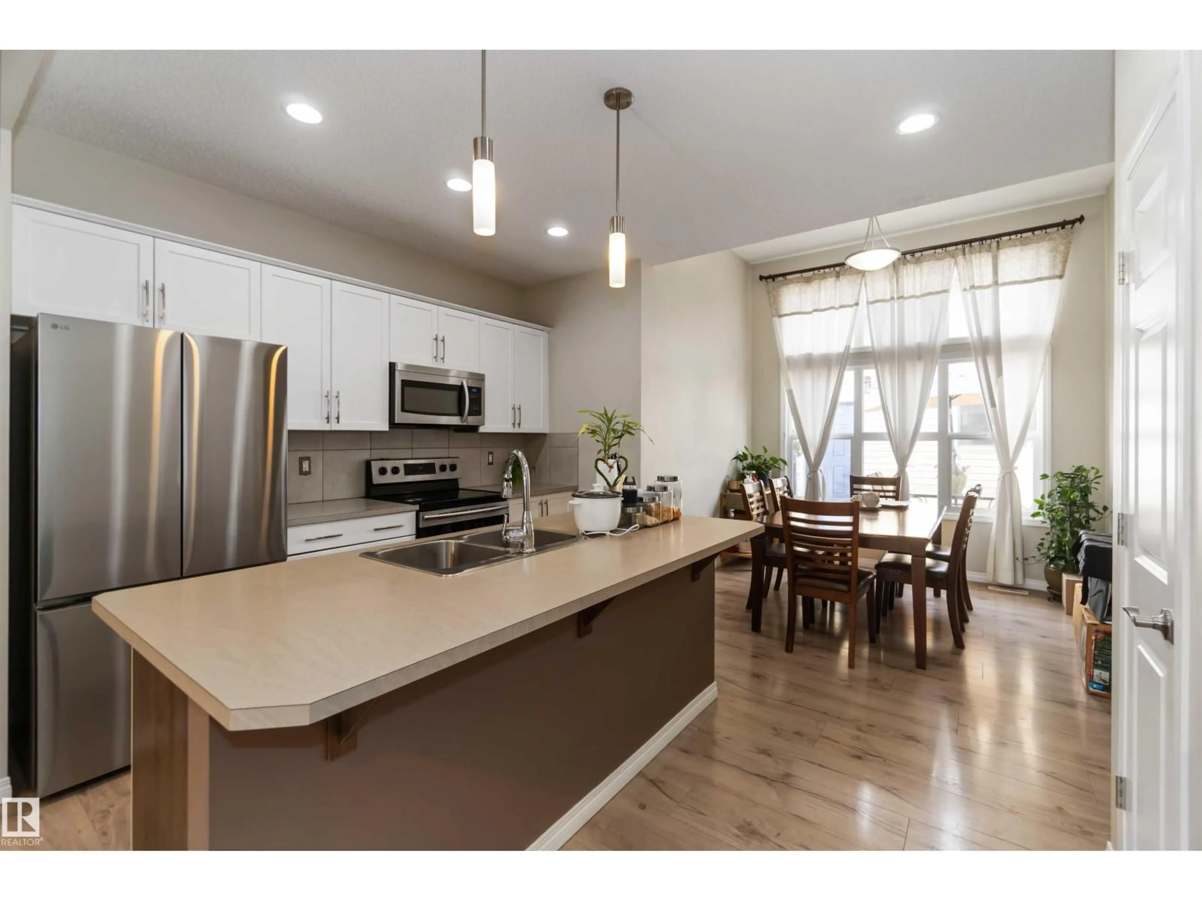 Open concept kitchen, wood/laminate floor for NW - 9932 221 ST, Edmonton Alberta T5T4M7