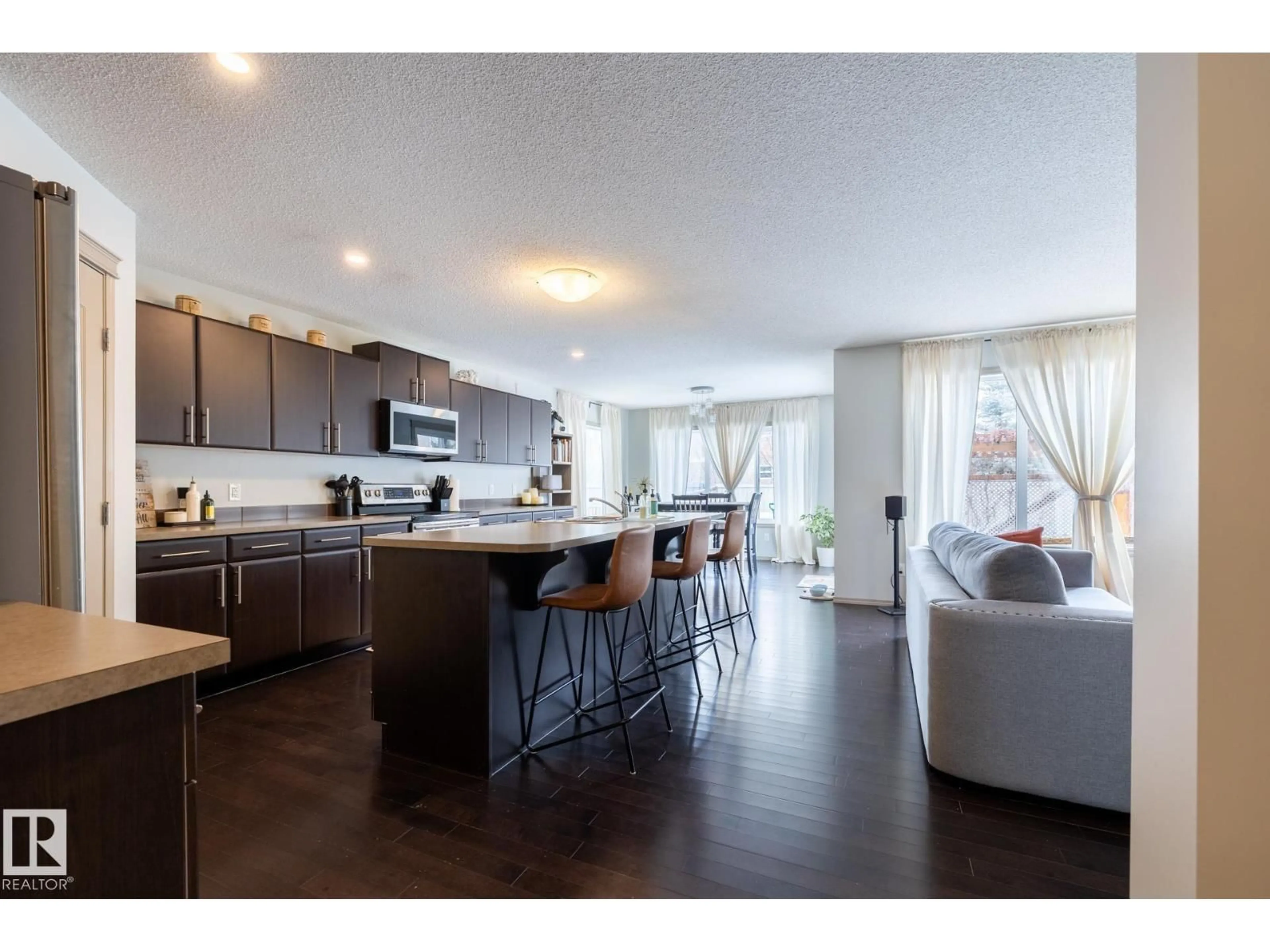 Open concept kitchen, wood/laminate floor for 3312 17B AV, Edmonton Alberta T6T0P3