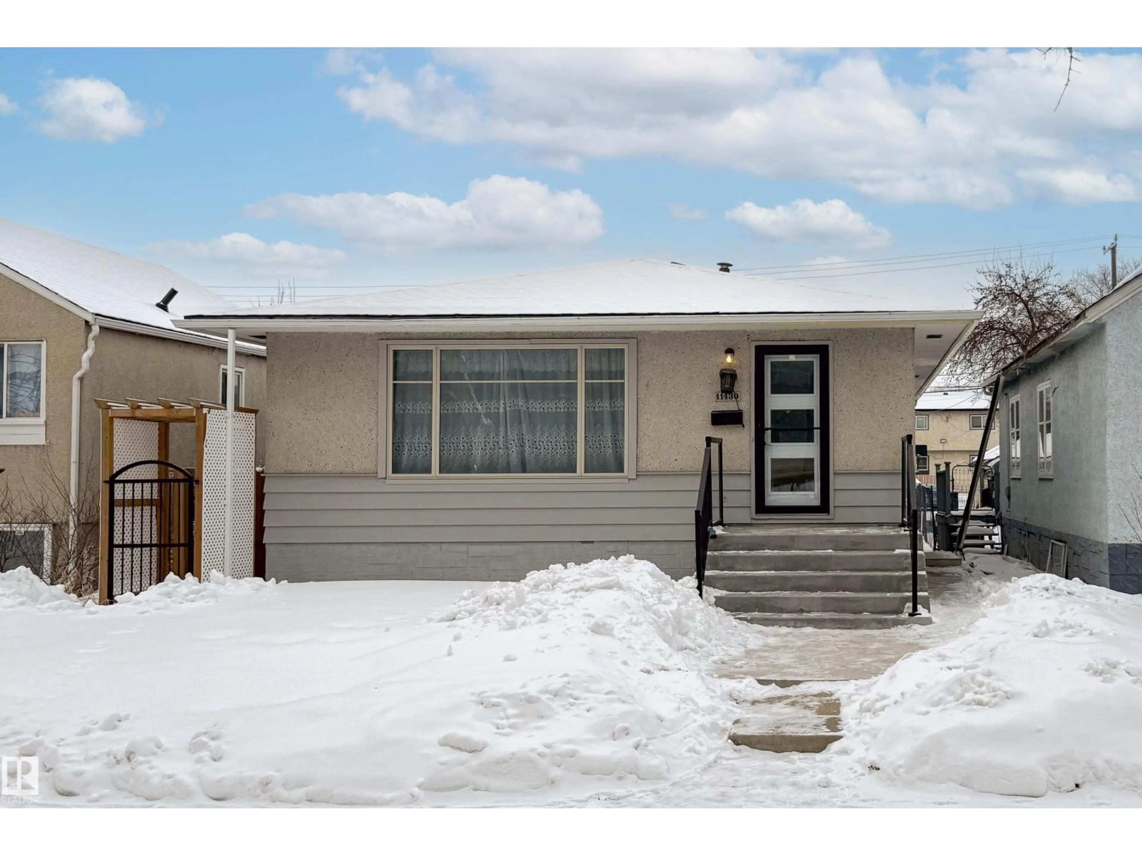 Home with vinyl exterior material, street for NW - 11430 81 ST, Edmonton Alberta T5B2R6