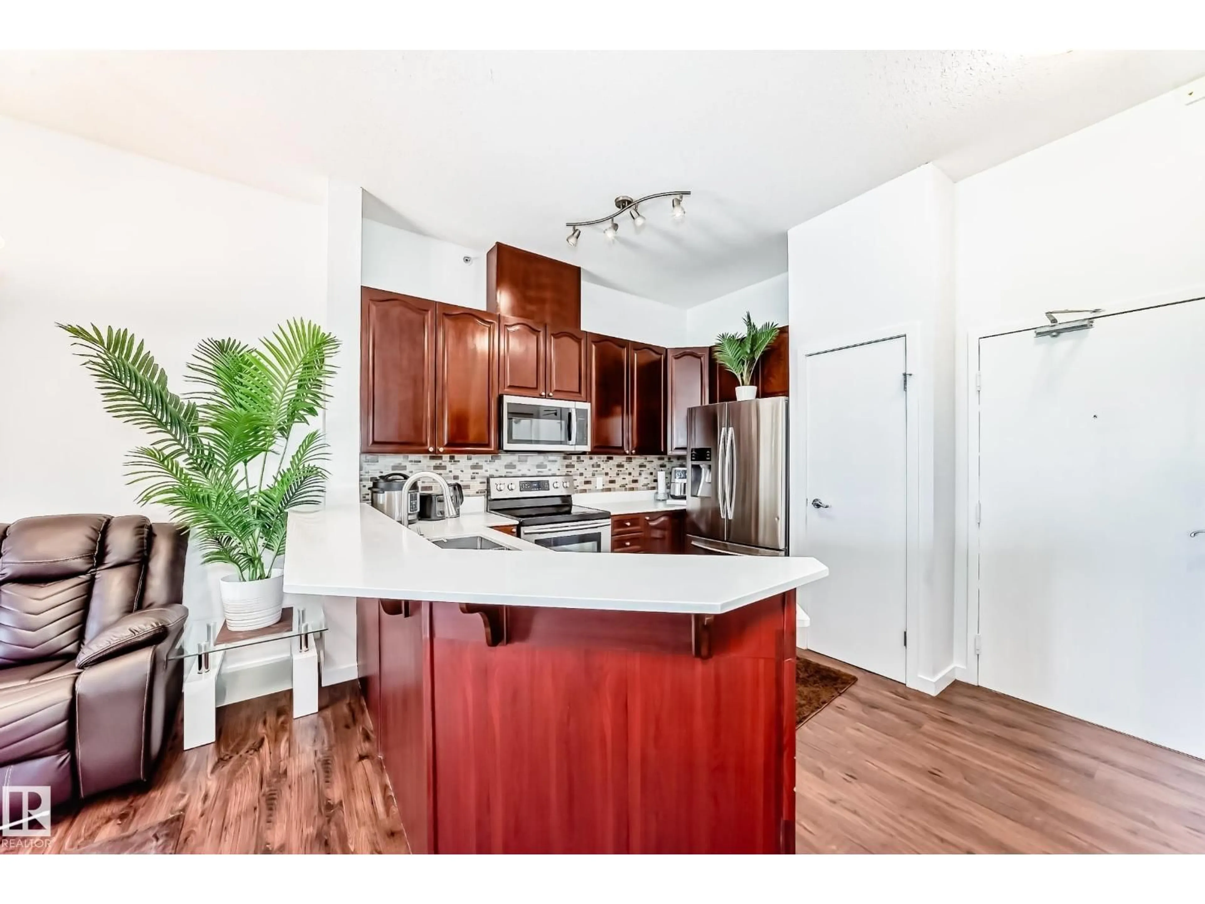 Open concept kitchen, wood/laminate floor for #412 - 4312 139 AV, Edmonton Alberta T5Y3J4