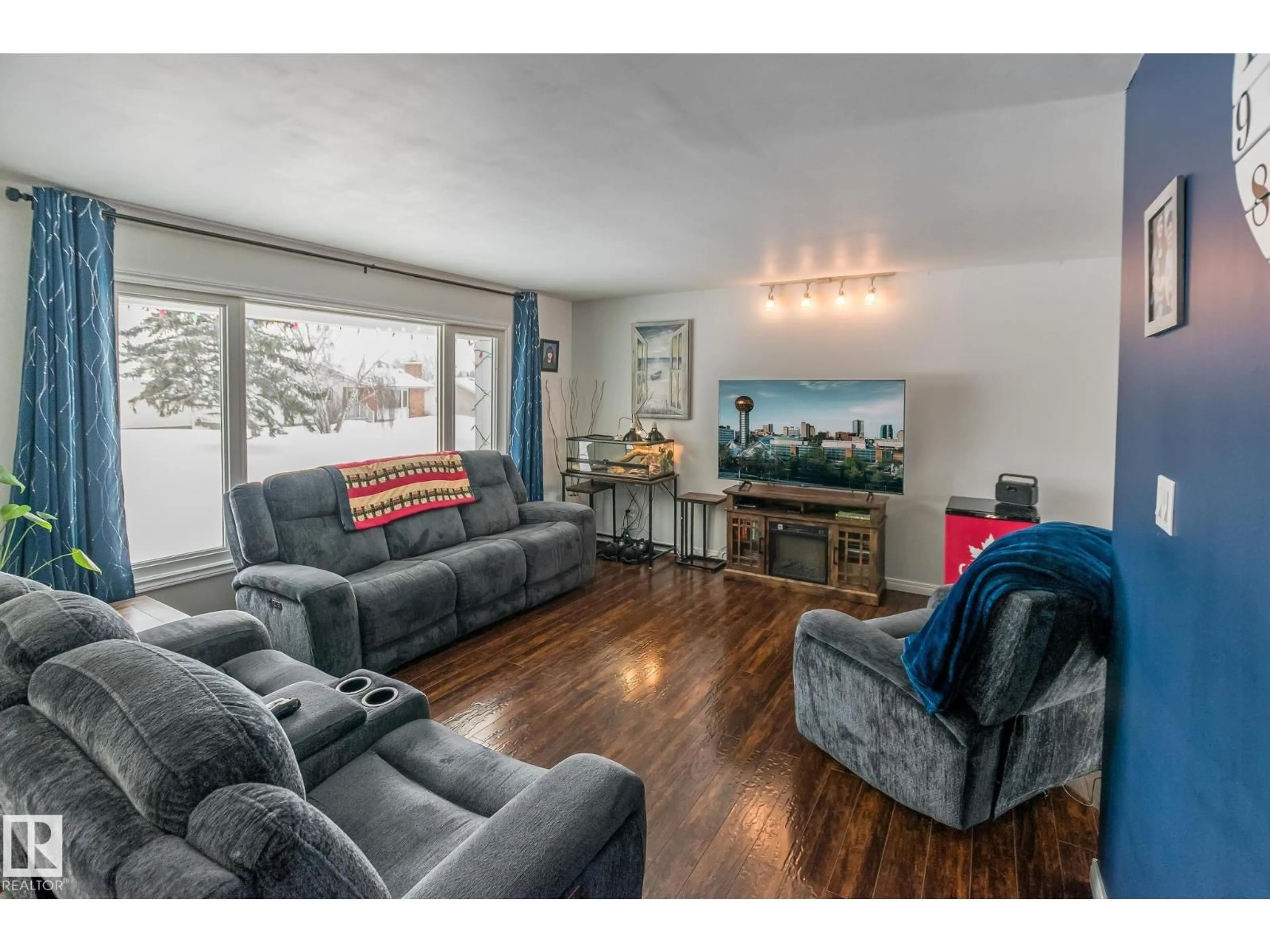 Living room with furniture, wood/laminate floor for 4403 44 AV, Bonnyville Town Alberta T9N1X1