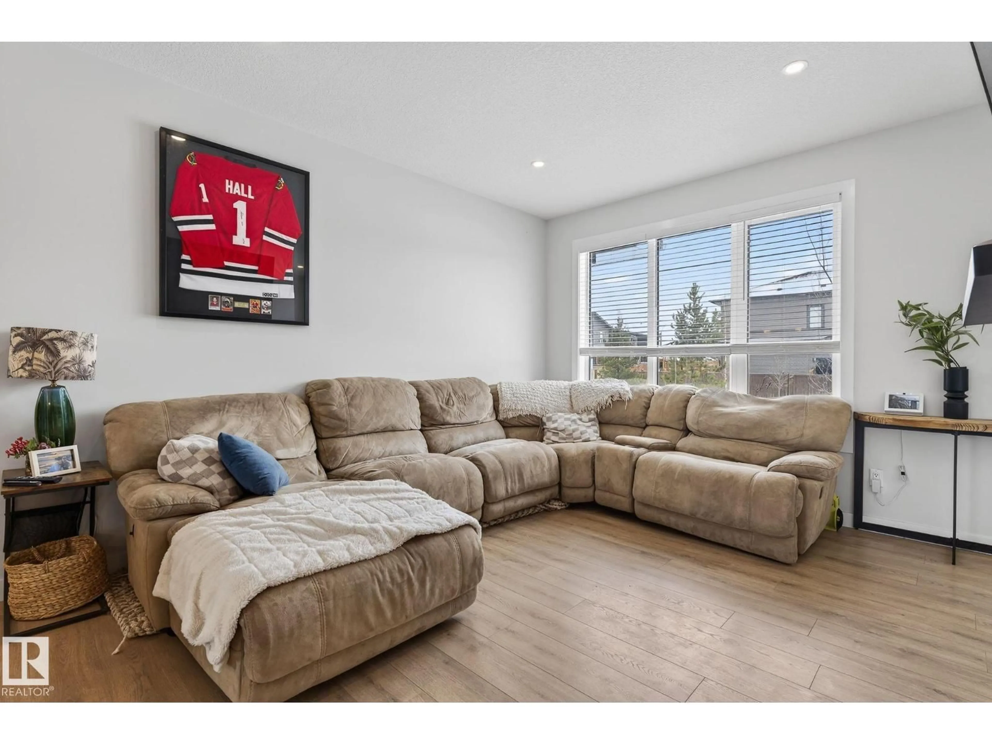 Living room with furniture, wood/laminate floor for 17 FENWYCK BV, Spruce Grove Alberta T7X3R6