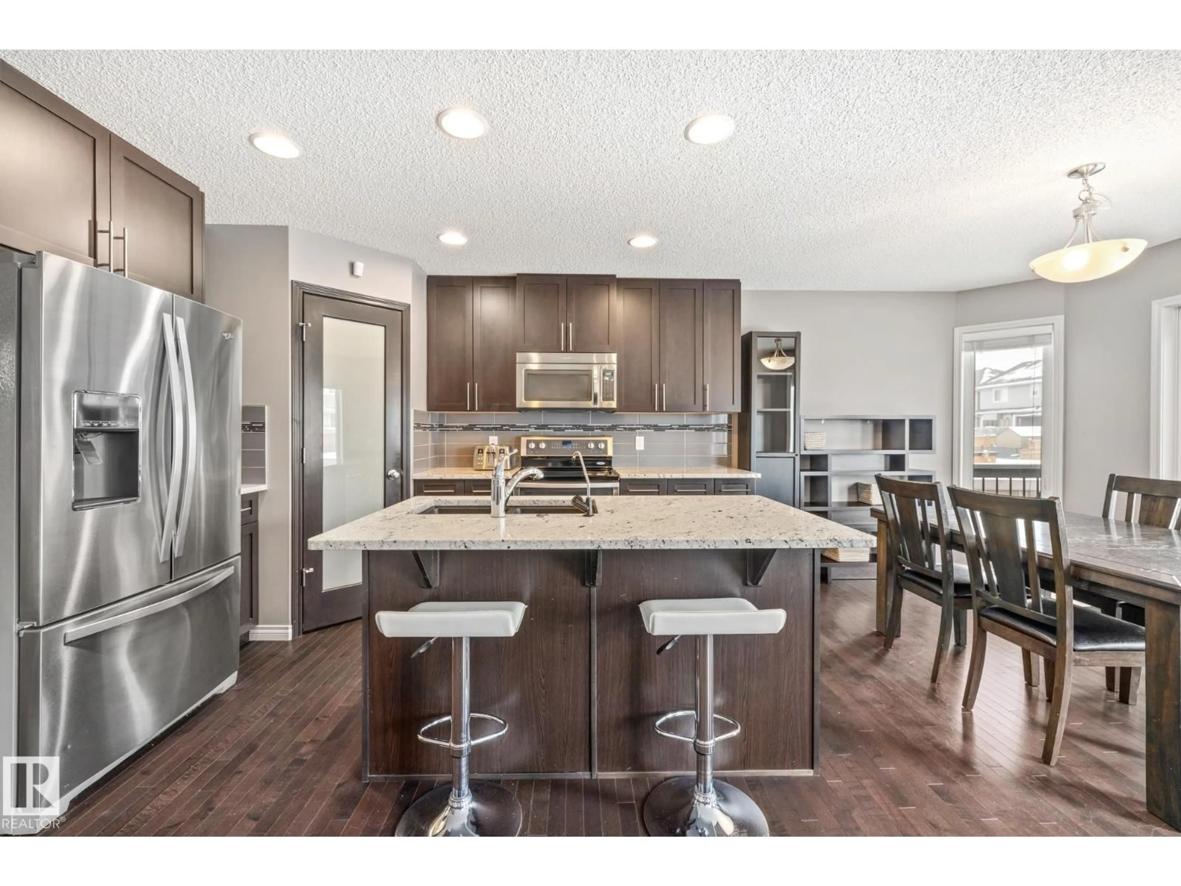 Open concept kitchen, wood/laminate floor for 10616 97 ST, Morinville Alberta T8R0B8