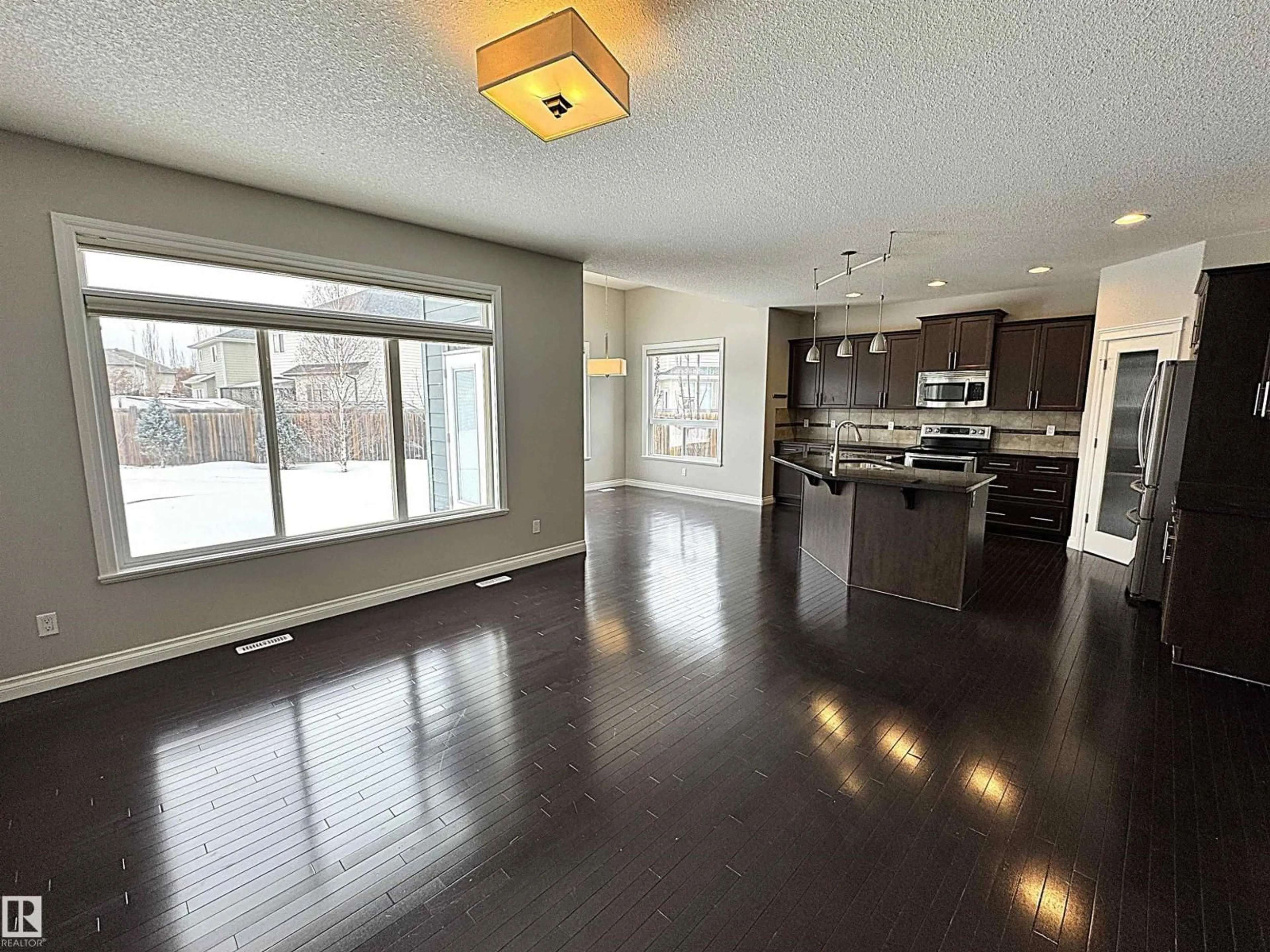 Open concept kitchen, wood/laminate floor for SW - 1473 WATES LI, Edmonton Alberta T6W0V1