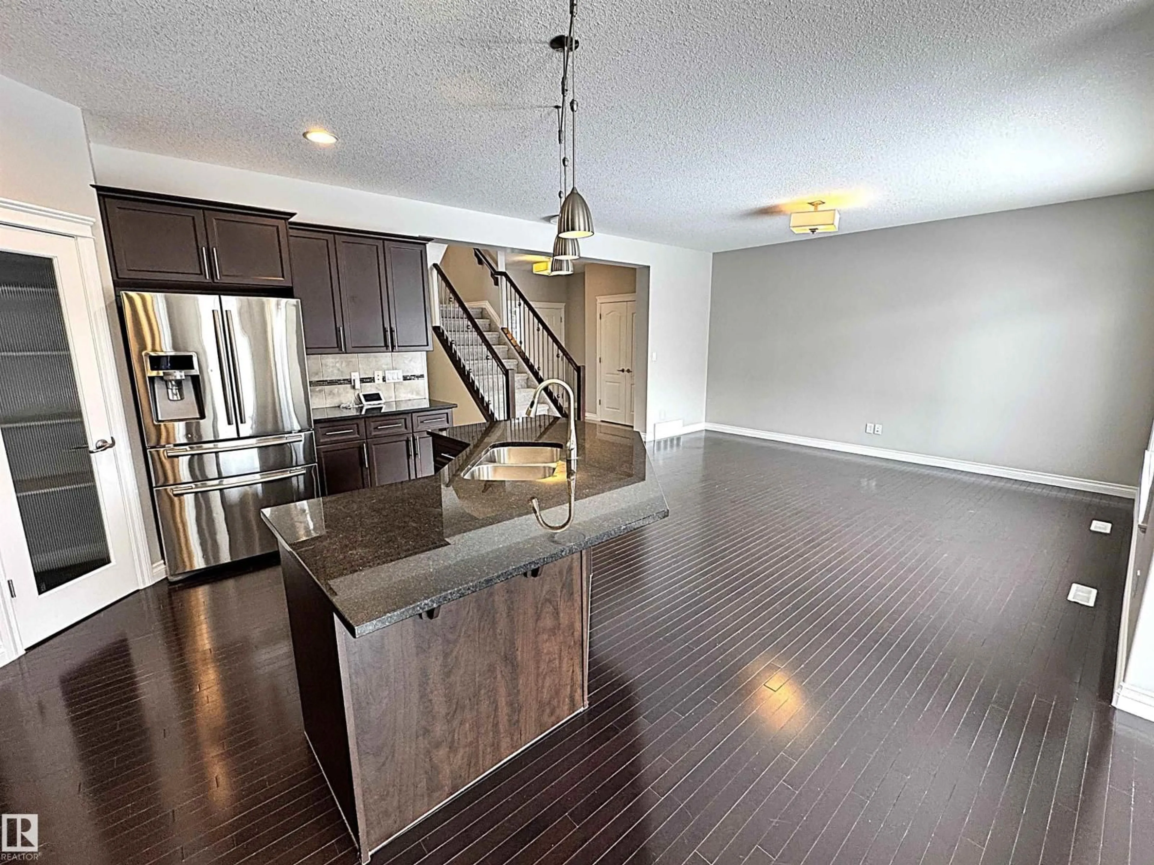 Open concept kitchen, wood/laminate floor for SW - 1473 WATES LI, Edmonton Alberta T6W0V1