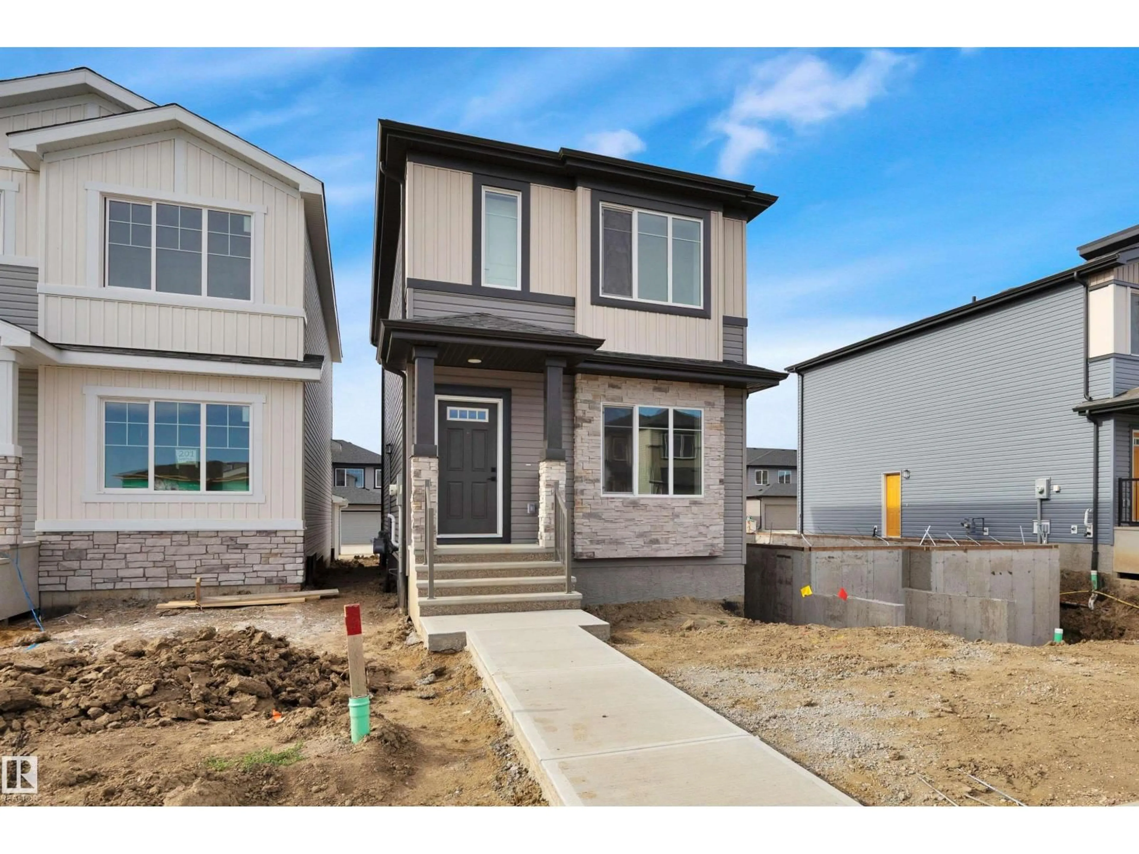 Home with vinyl exterior material, street for 203 WATTLE RD, Leduc Alberta T9E1L3