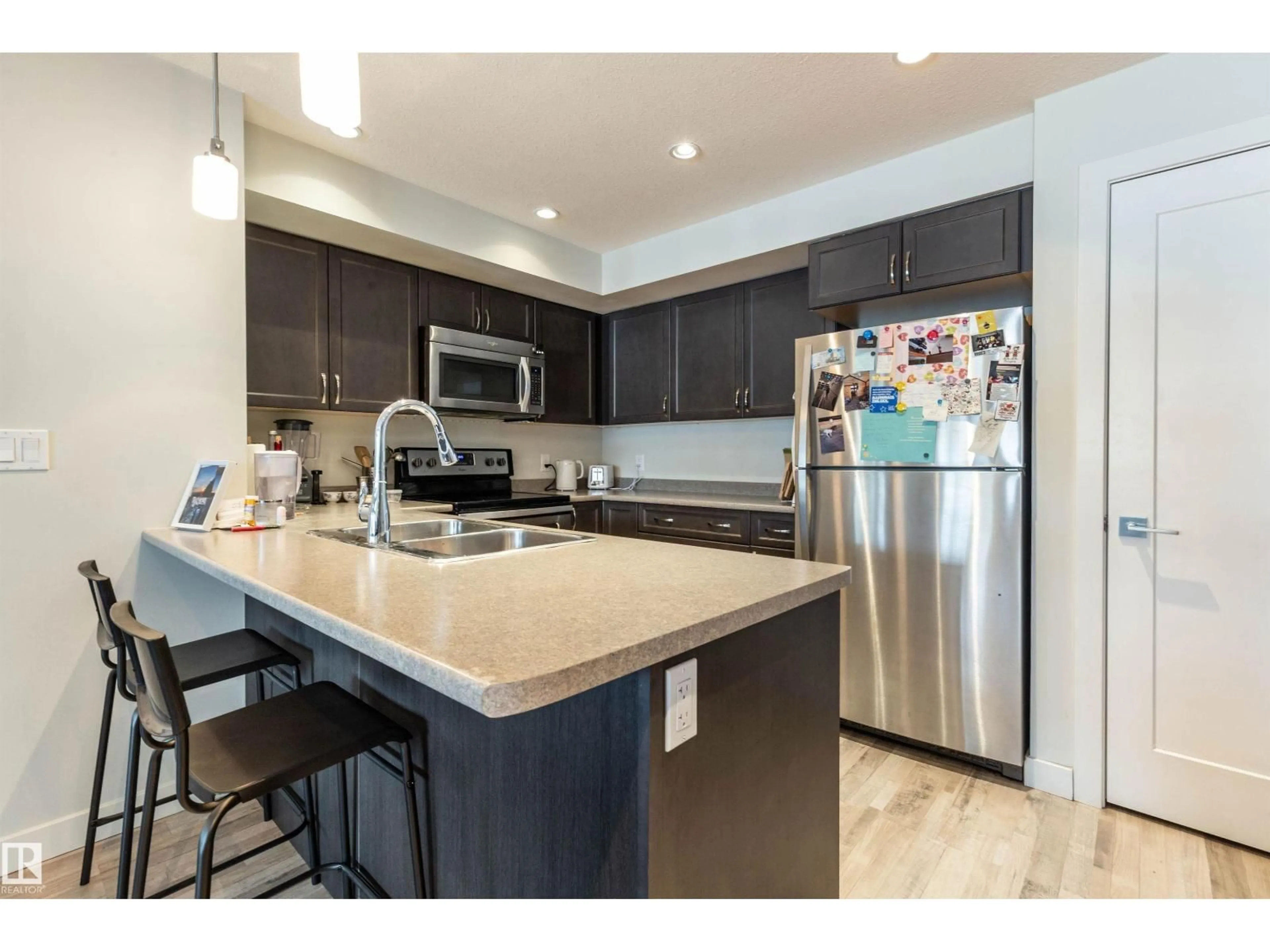 Open concept kitchen, wood/laminate floor for 109 - 5029 EDGEMONT BV, Edmonton Alberta T6M0S8