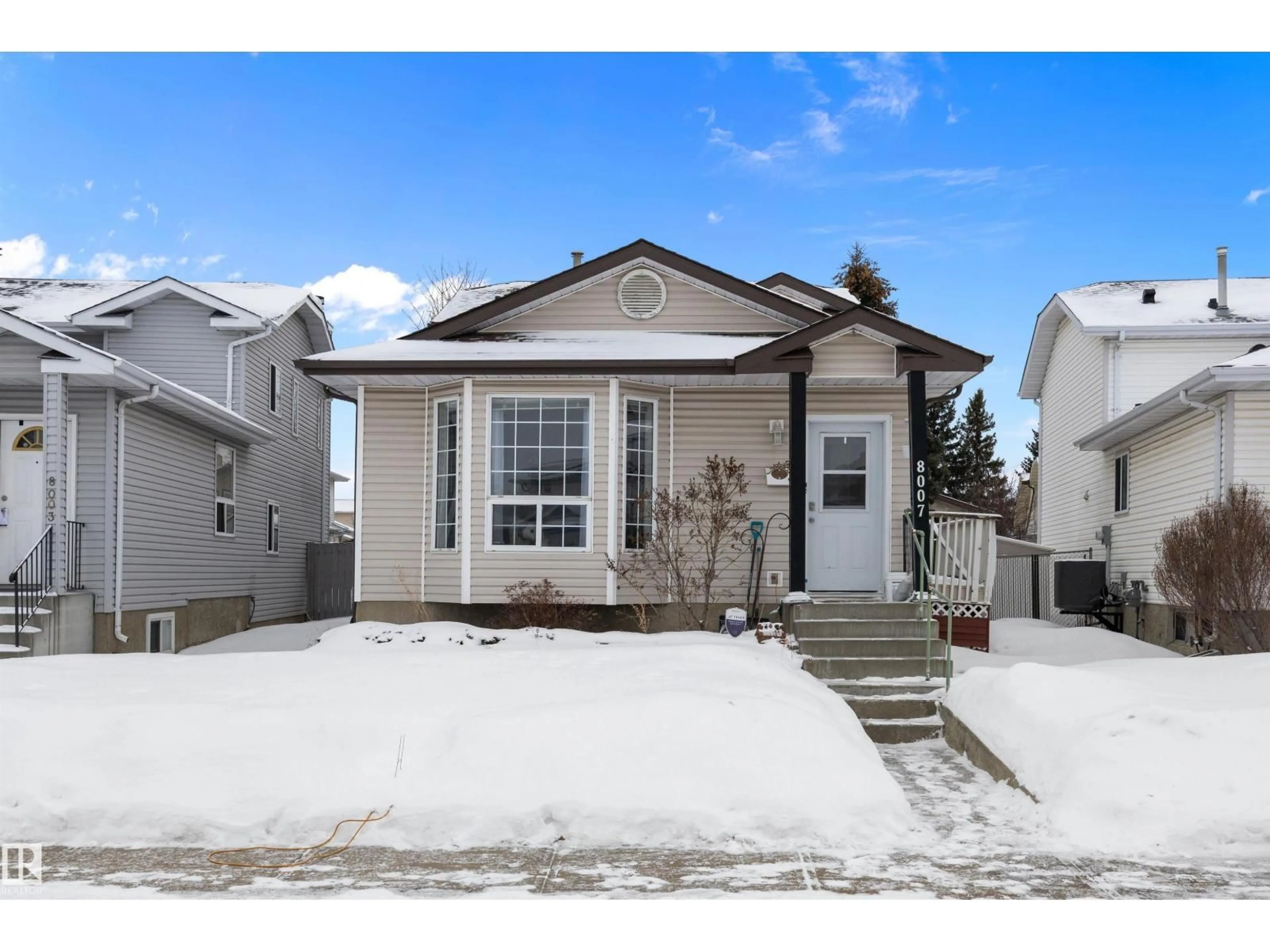 Home with vinyl exterior material, street for 8007 160 AV NW, Edmonton Alberta T5Z3A2