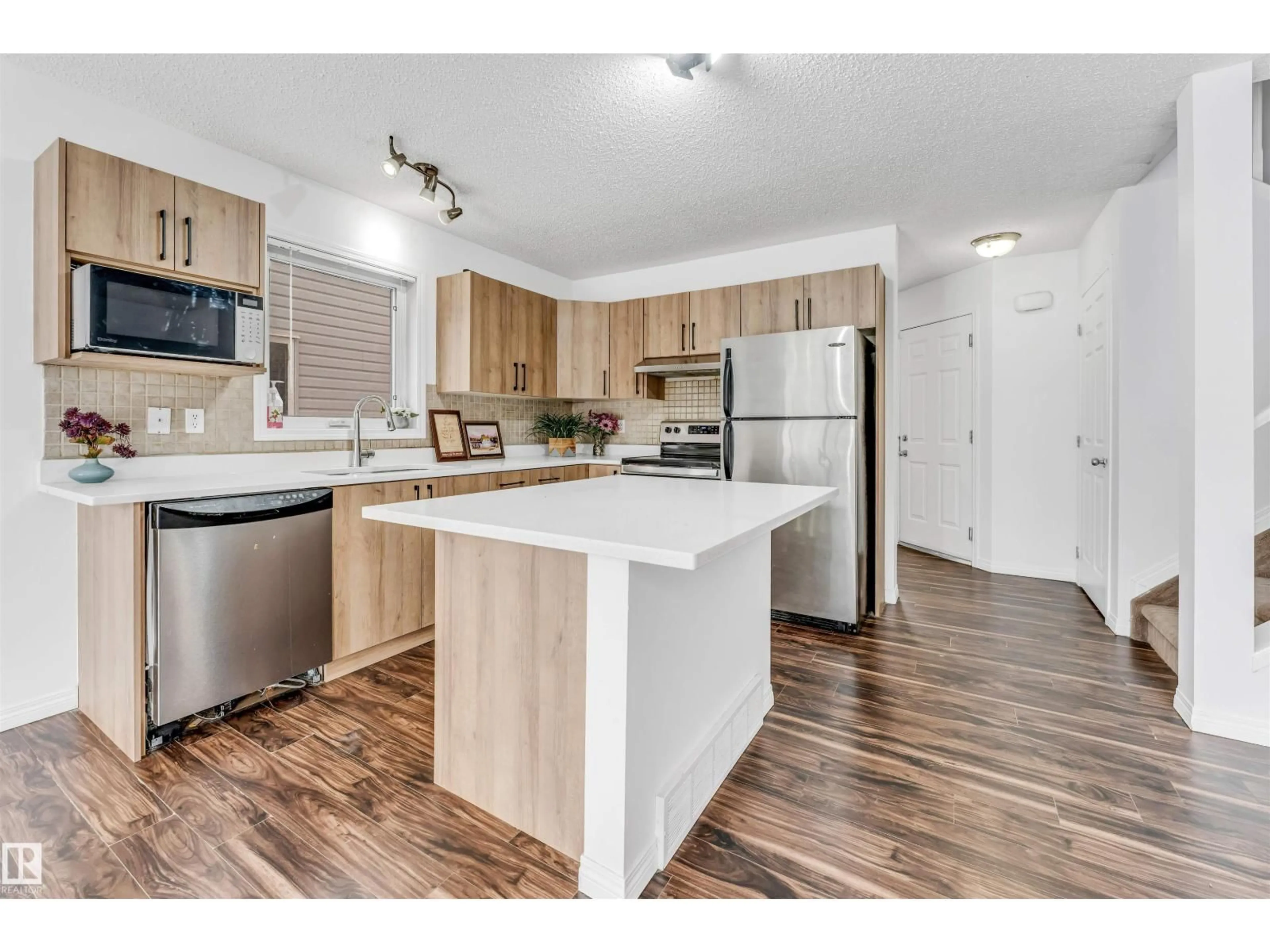 Open concept kitchen, wood/laminate floor for 4350 - 96 23 ST, Edmonton Alberta T6T1X8