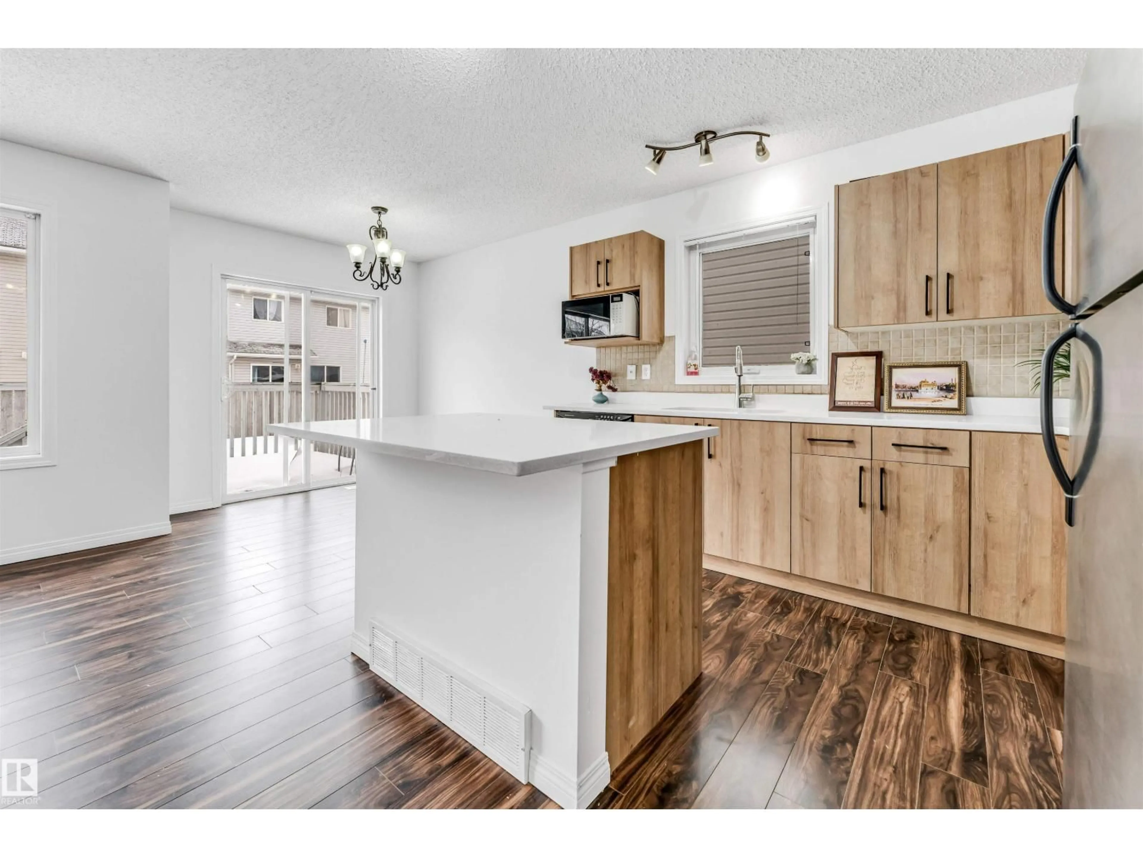 Open concept kitchen, wood/laminate floor for 4350 - 96 23 ST, Edmonton Alberta T6T1X8