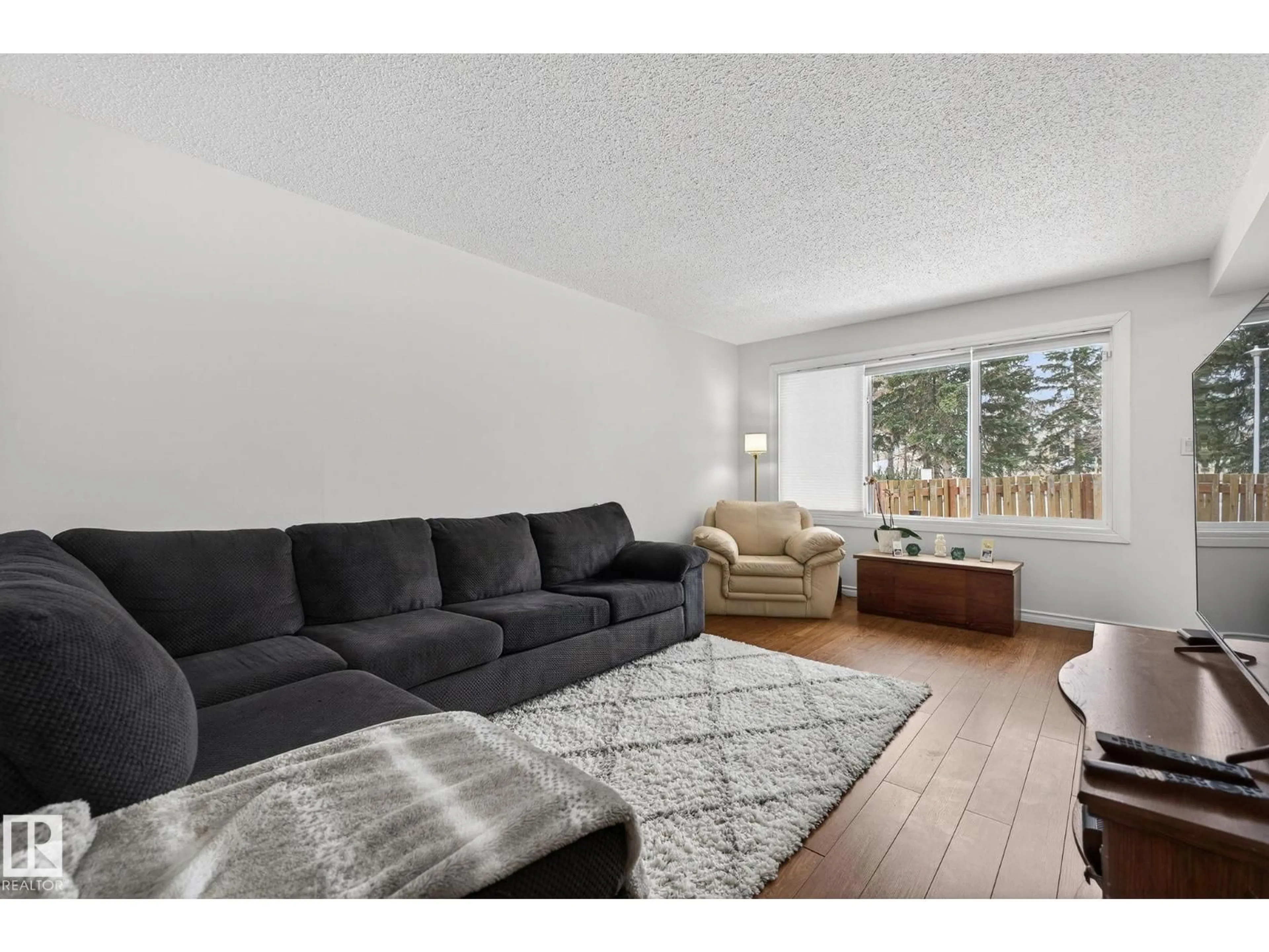 Living room with furniture, wood/laminate floor for 207 CALLINGWOOD PL, Edmonton Alberta T5T2C6