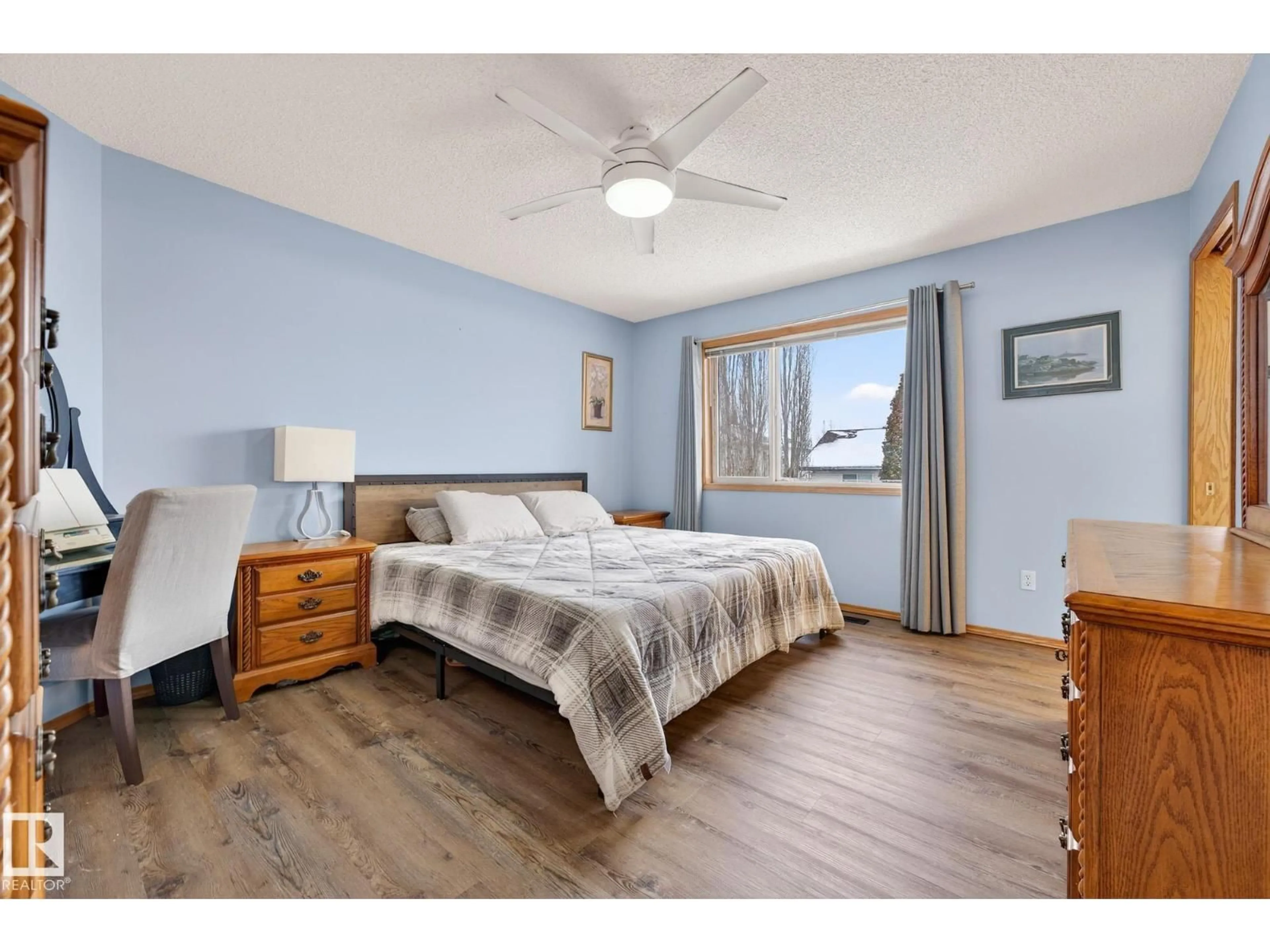 Bedroom with bed, wood/laminate floor for NW - 4027 31 ST, Edmonton Alberta T6T1L3