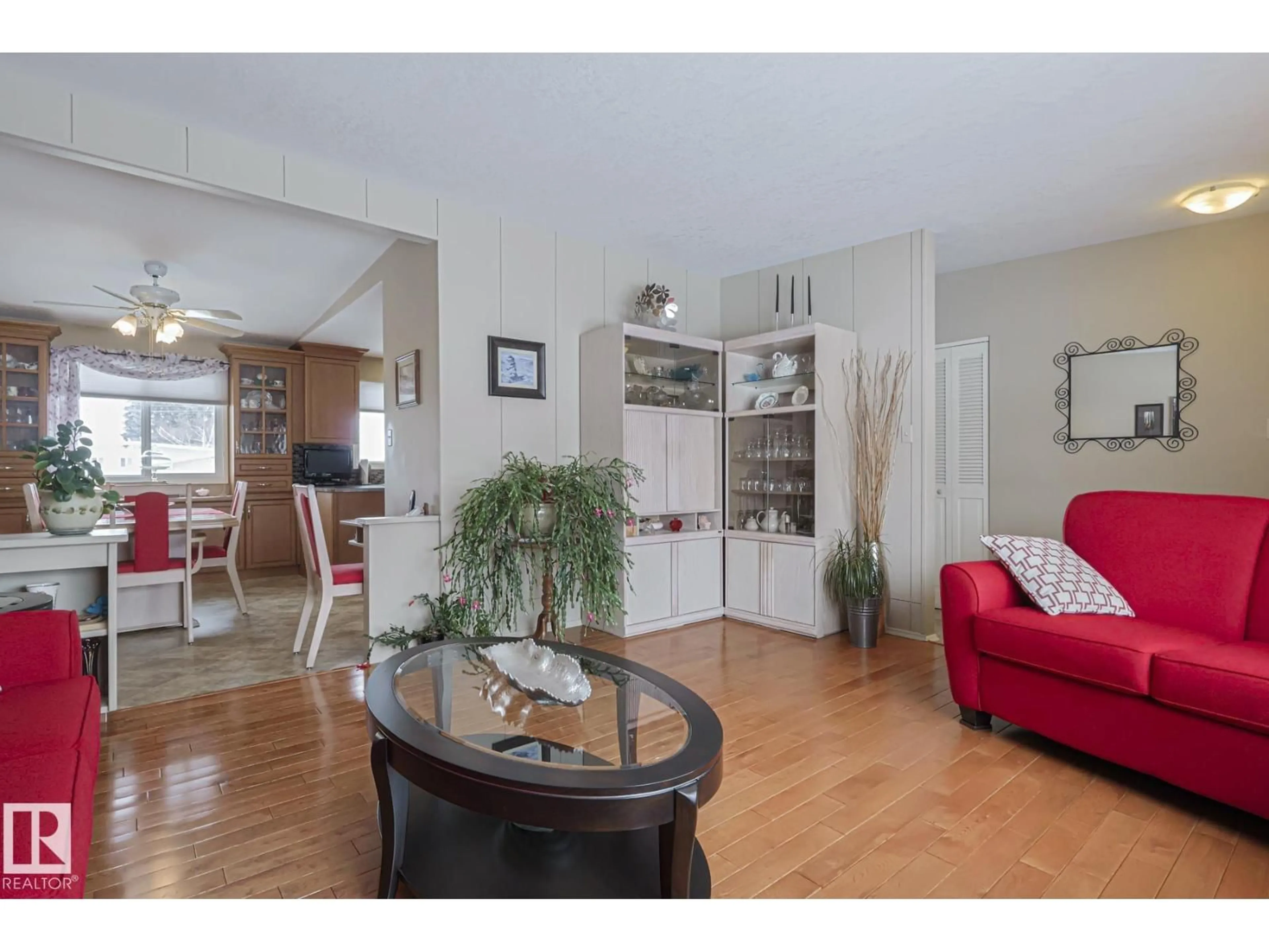 Living room with furniture, wood/laminate floor for 7604 DELWOOD RD, Edmonton Alberta T5C3B1