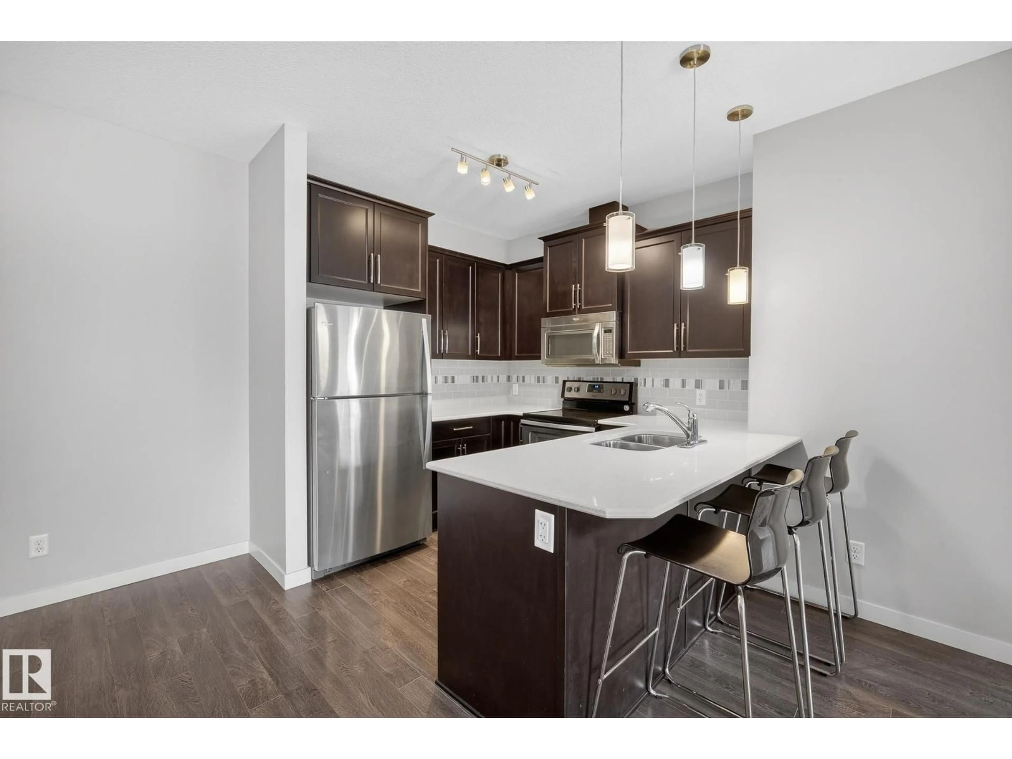 Open concept kitchen, wood/laminate floor for #206 - 206 WELSH DR, Edmonton Alberta T6X1Y7