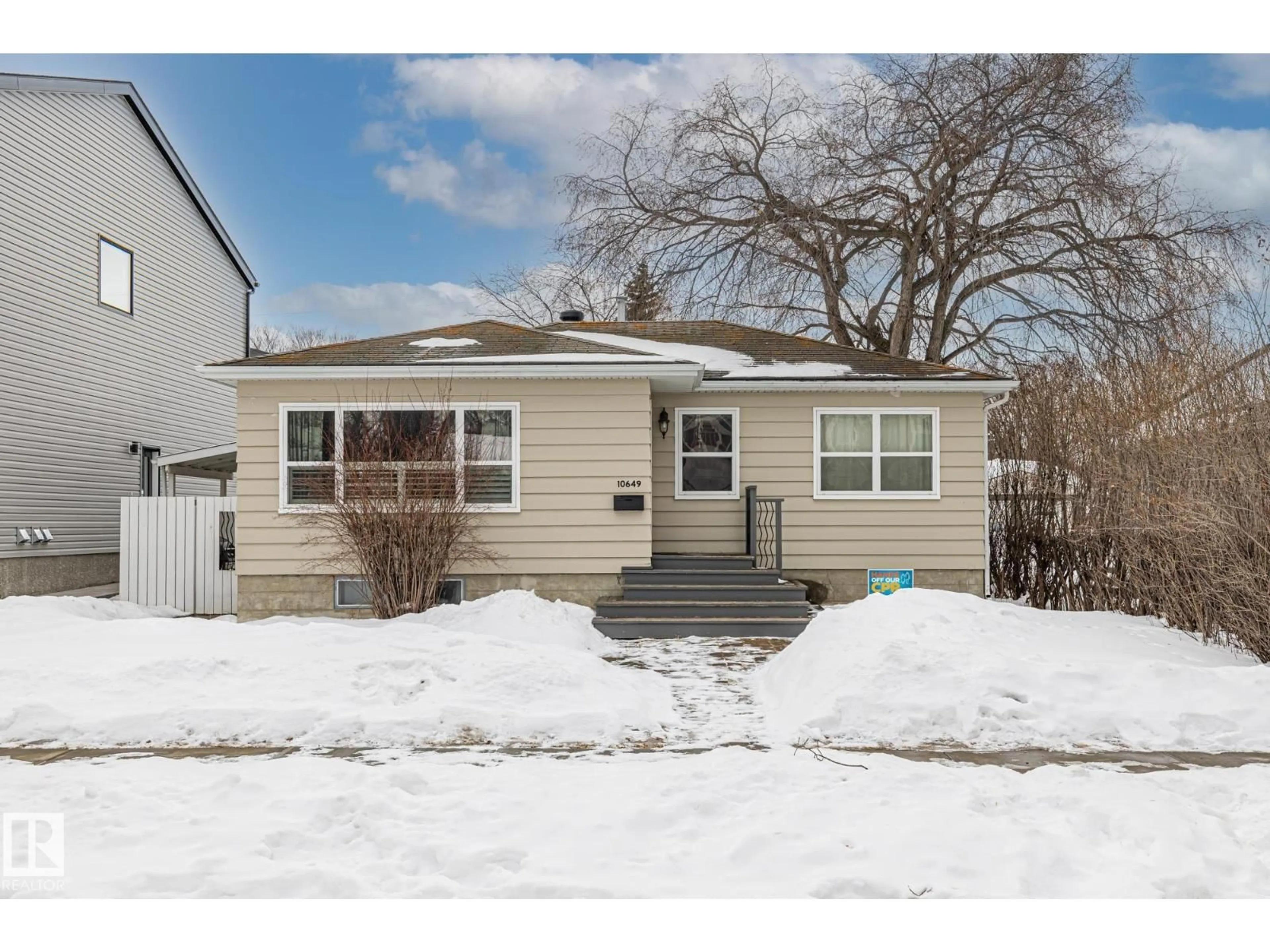 Home with vinyl exterior material, street for 10649 64 AV, Edmonton Alberta T6H1T1