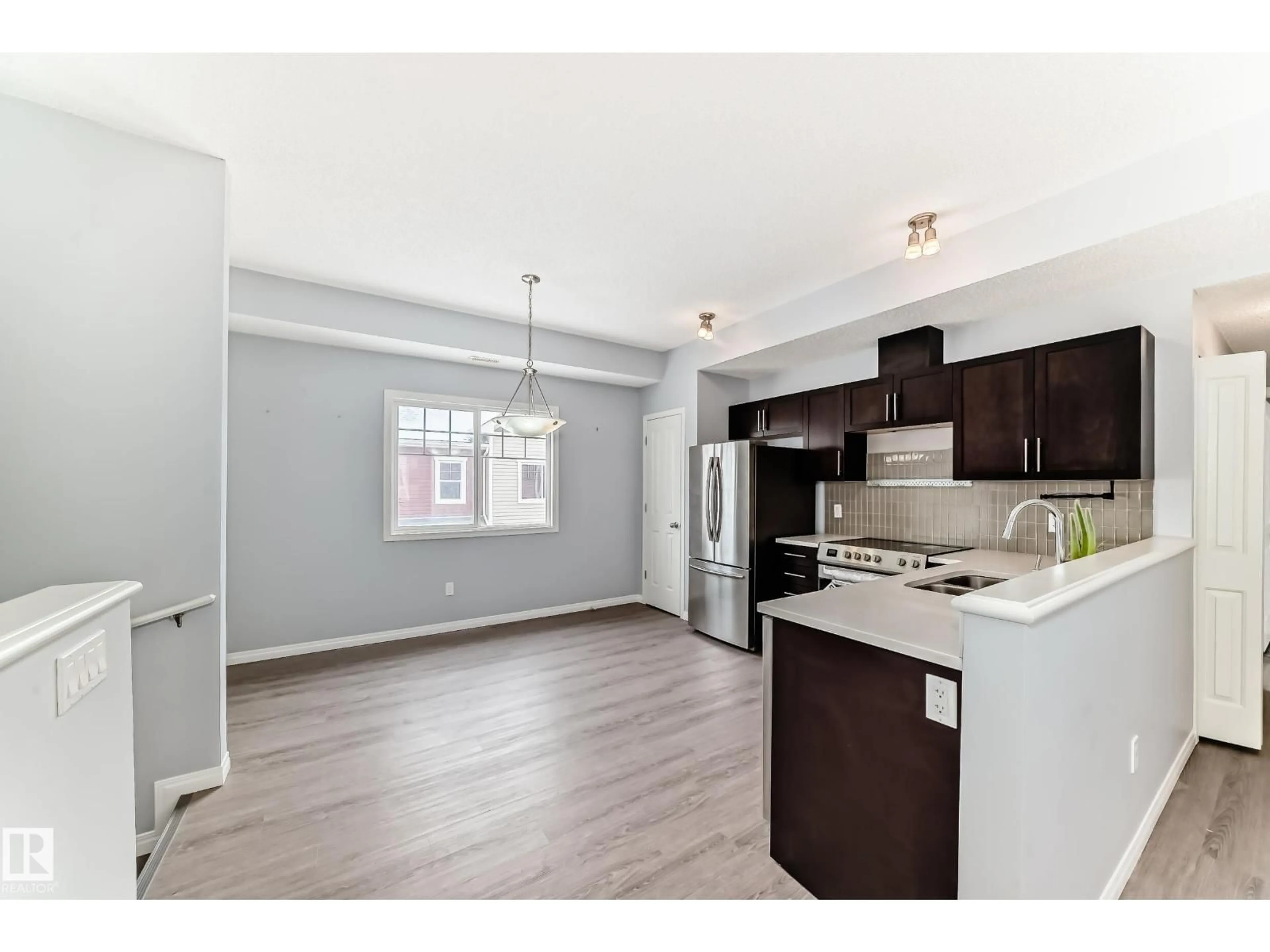 Open concept kitchen, wood/laminate floor for #47 - 460 HEMINGWAY RD, Edmonton Alberta T6M0M5