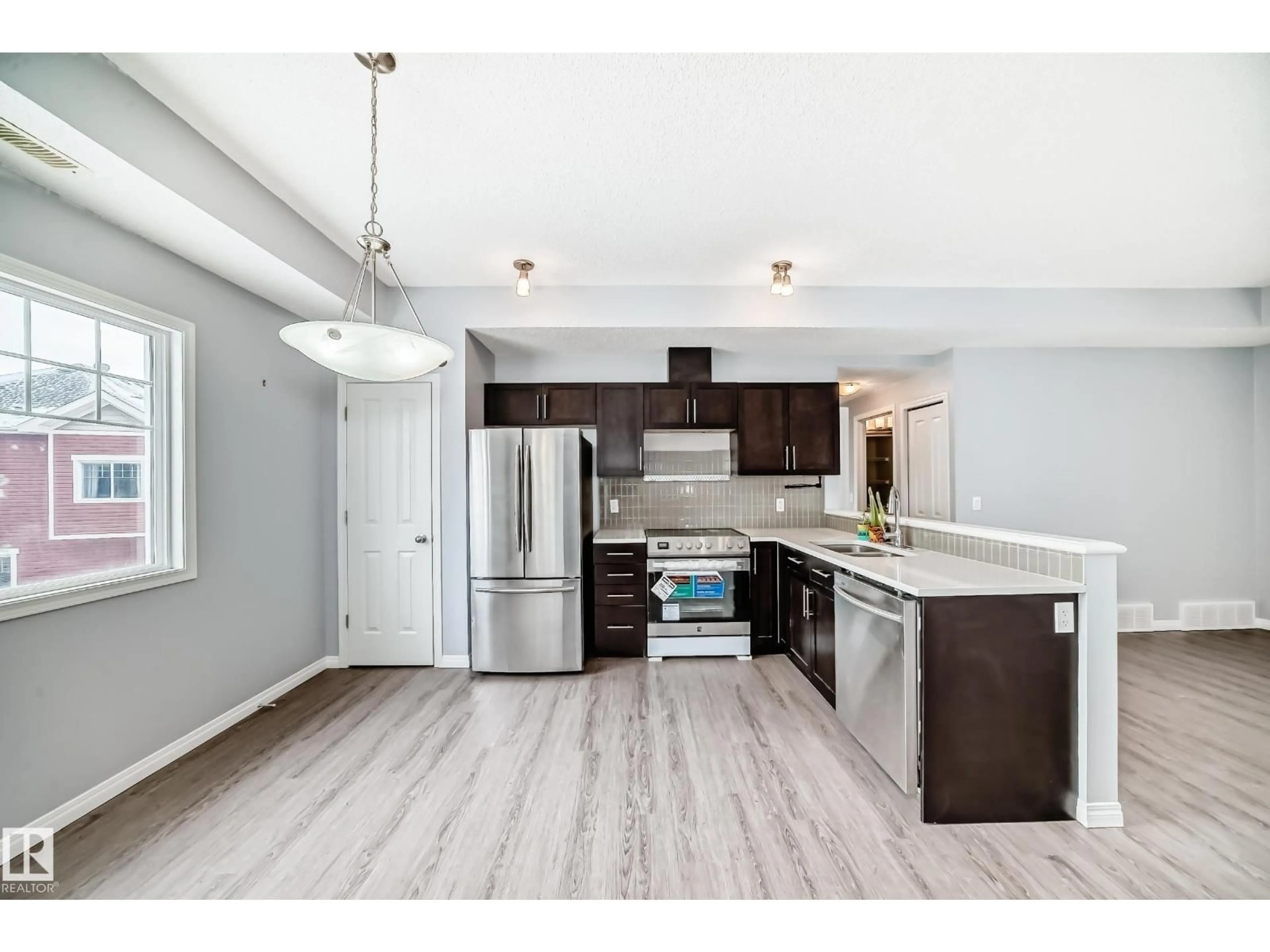 Open concept kitchen, wood/laminate floor for #47 - 460 HEMINGWAY RD, Edmonton Alberta T6M0M5