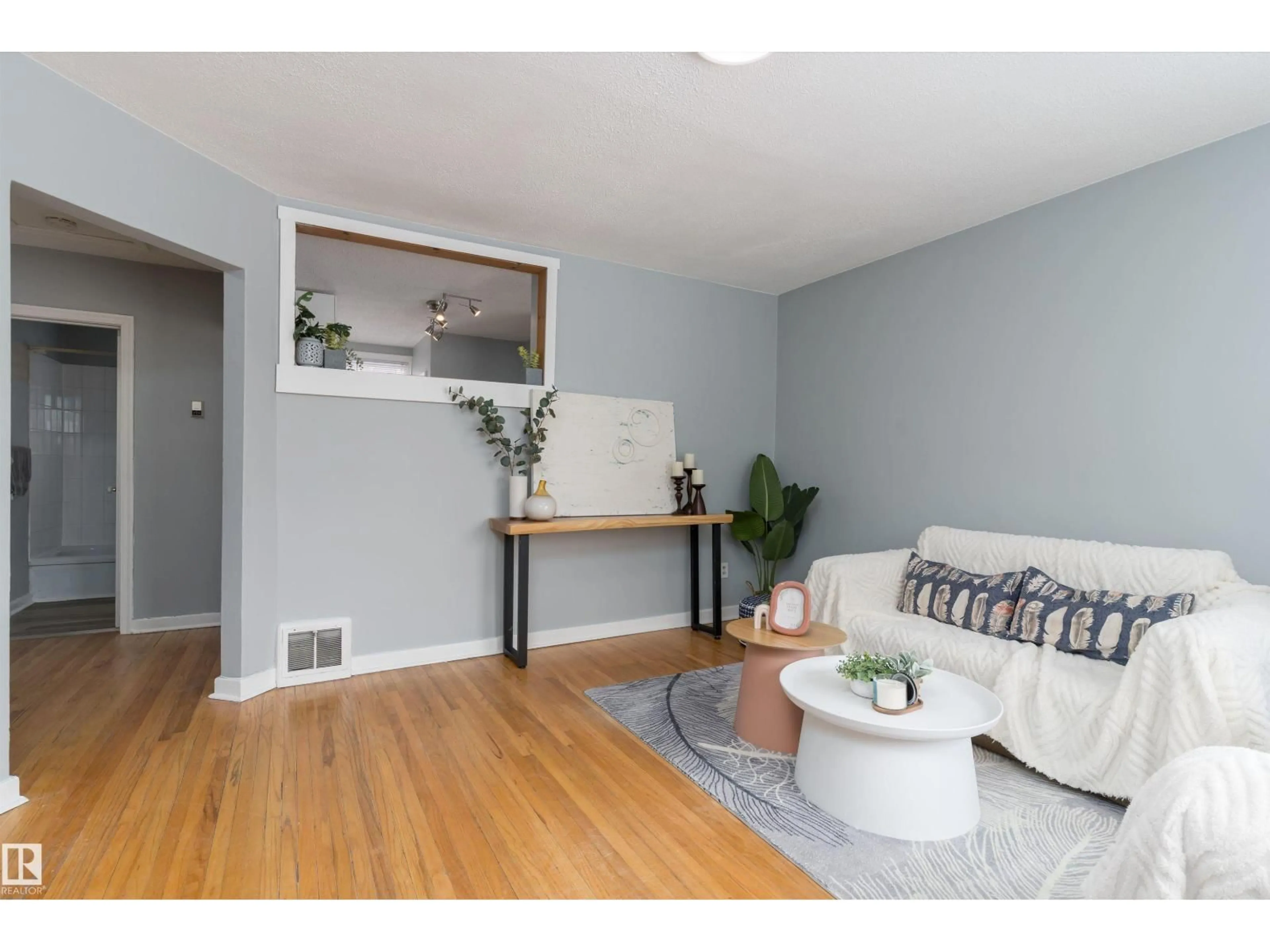 Living room with furniture, wood/laminate floor for 8971 81 AV, Edmonton Alberta T6C0W7