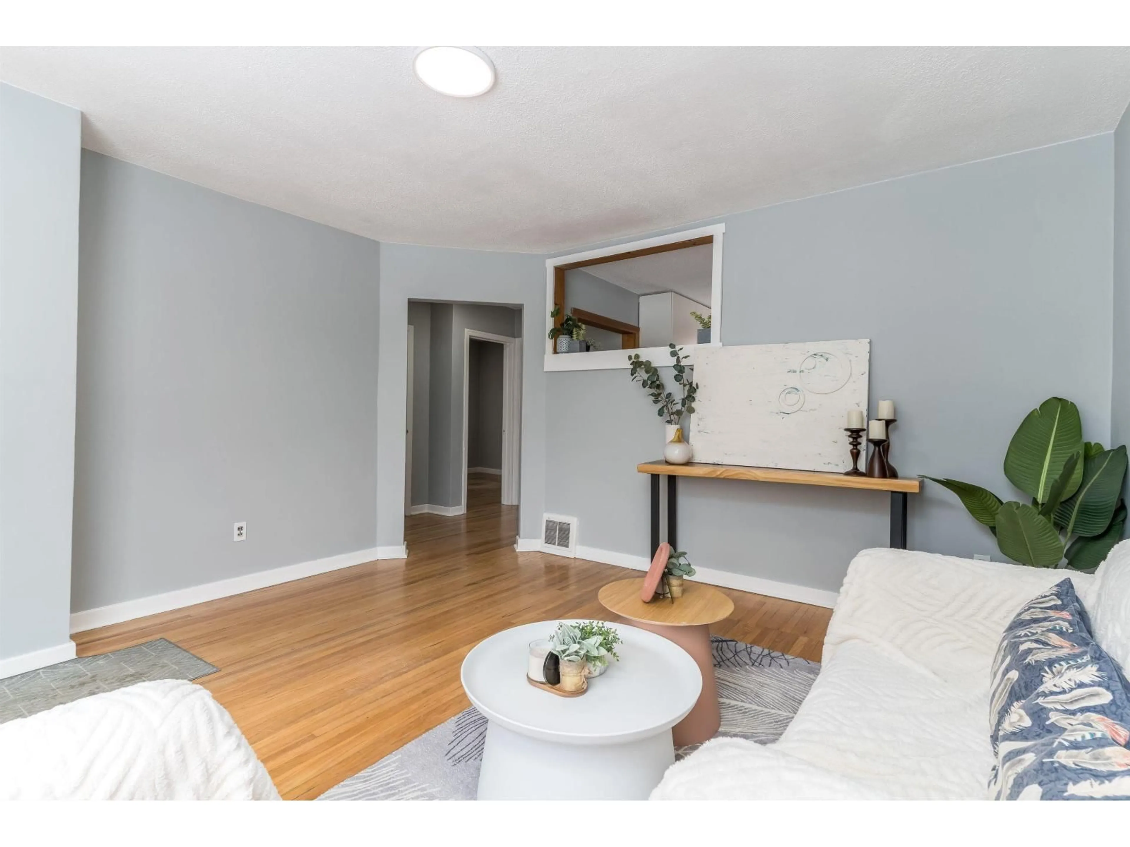 Living room with furniture, wood/laminate floor for 8971 81 AV, Edmonton Alberta T6C0W7