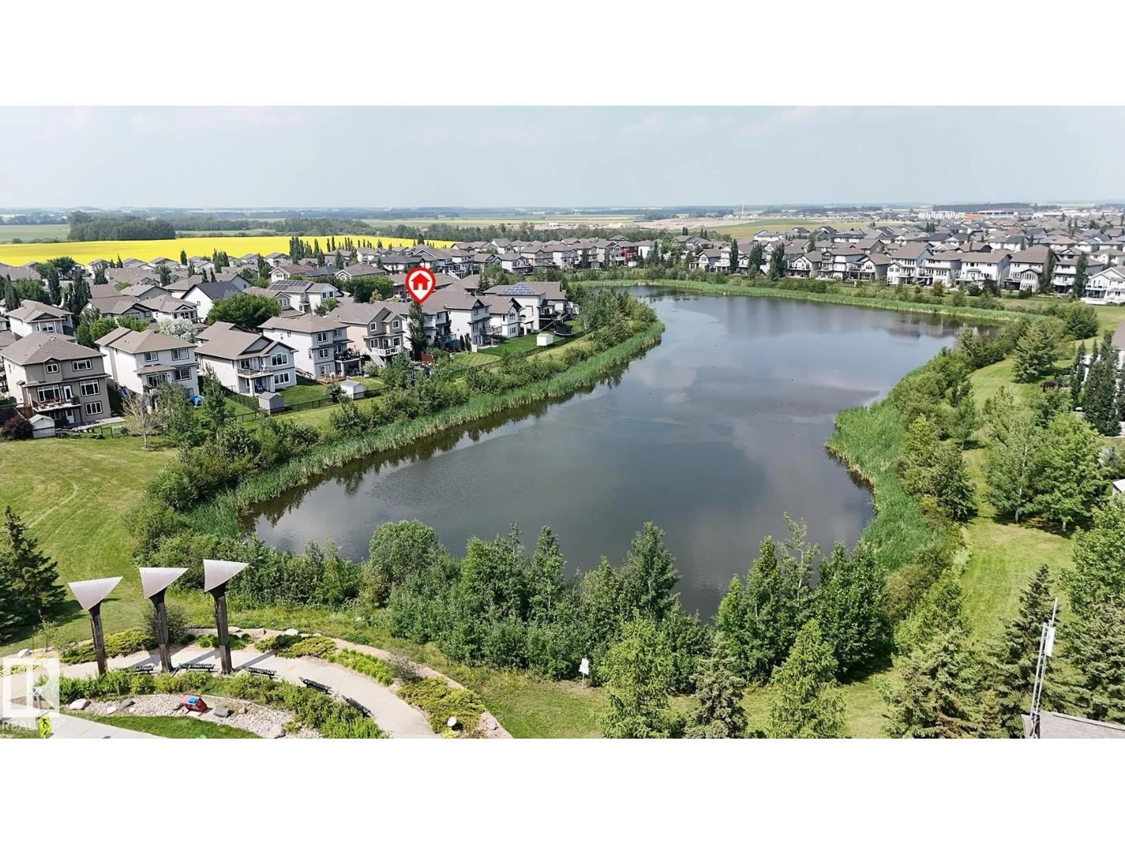A pic from outside/outdoor area/front of a property/back of a property/a pic from drone, water/lake/river/ocean view for 17 SWEETBERRY CV, Leduc Alberta T9E0L5