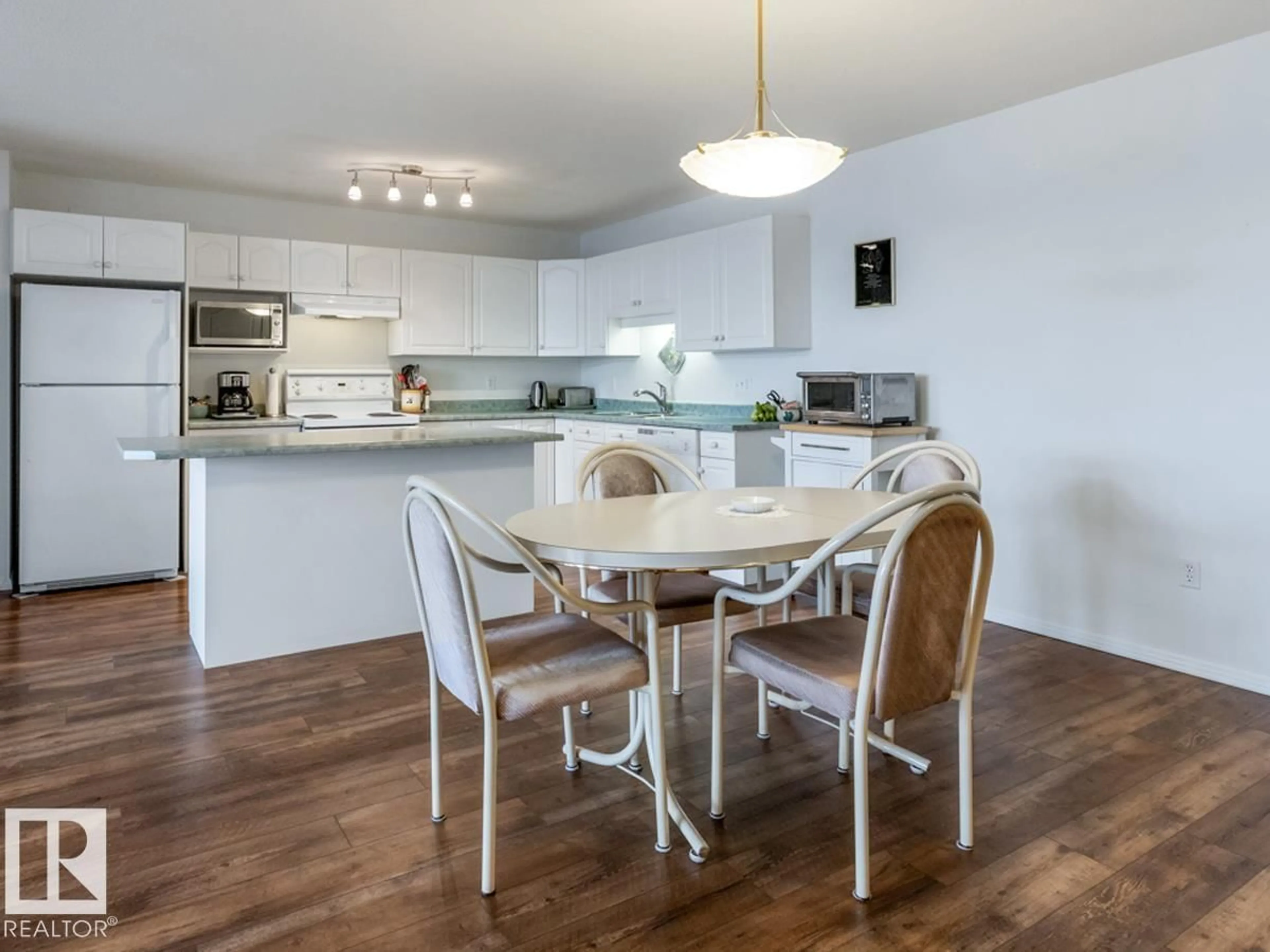 Open concept kitchen, wood/laminate floor for #312 - 10421 42 AV, Edmonton Alberta T6J7C8