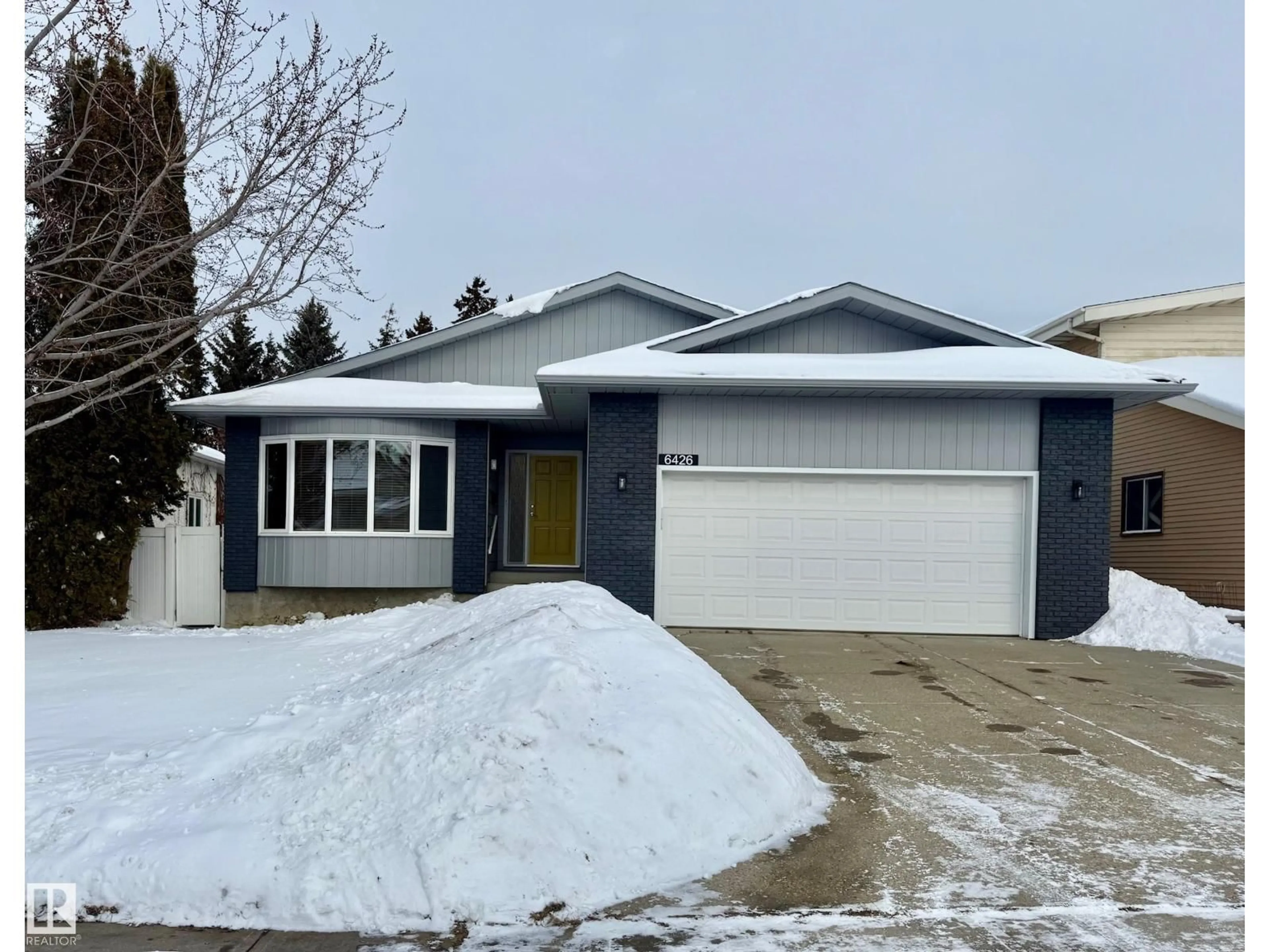 Home with vinyl exterior material, street for NW - 6426 37B AV, Edmonton Alberta T6L1R2