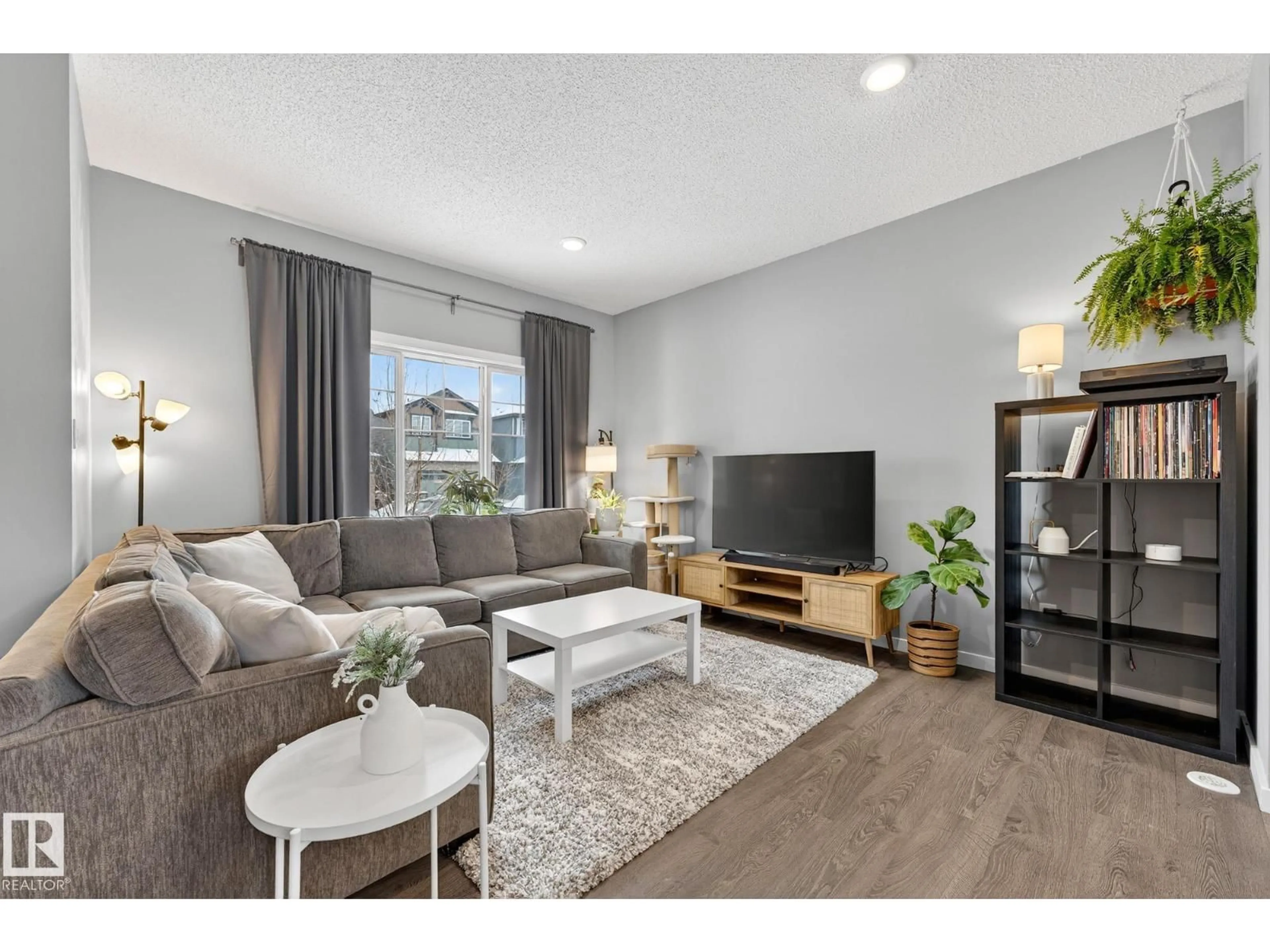 Living room with furniture, wood/laminate floor for NW - 22108 87 AV, Edmonton Alberta T5T7H7