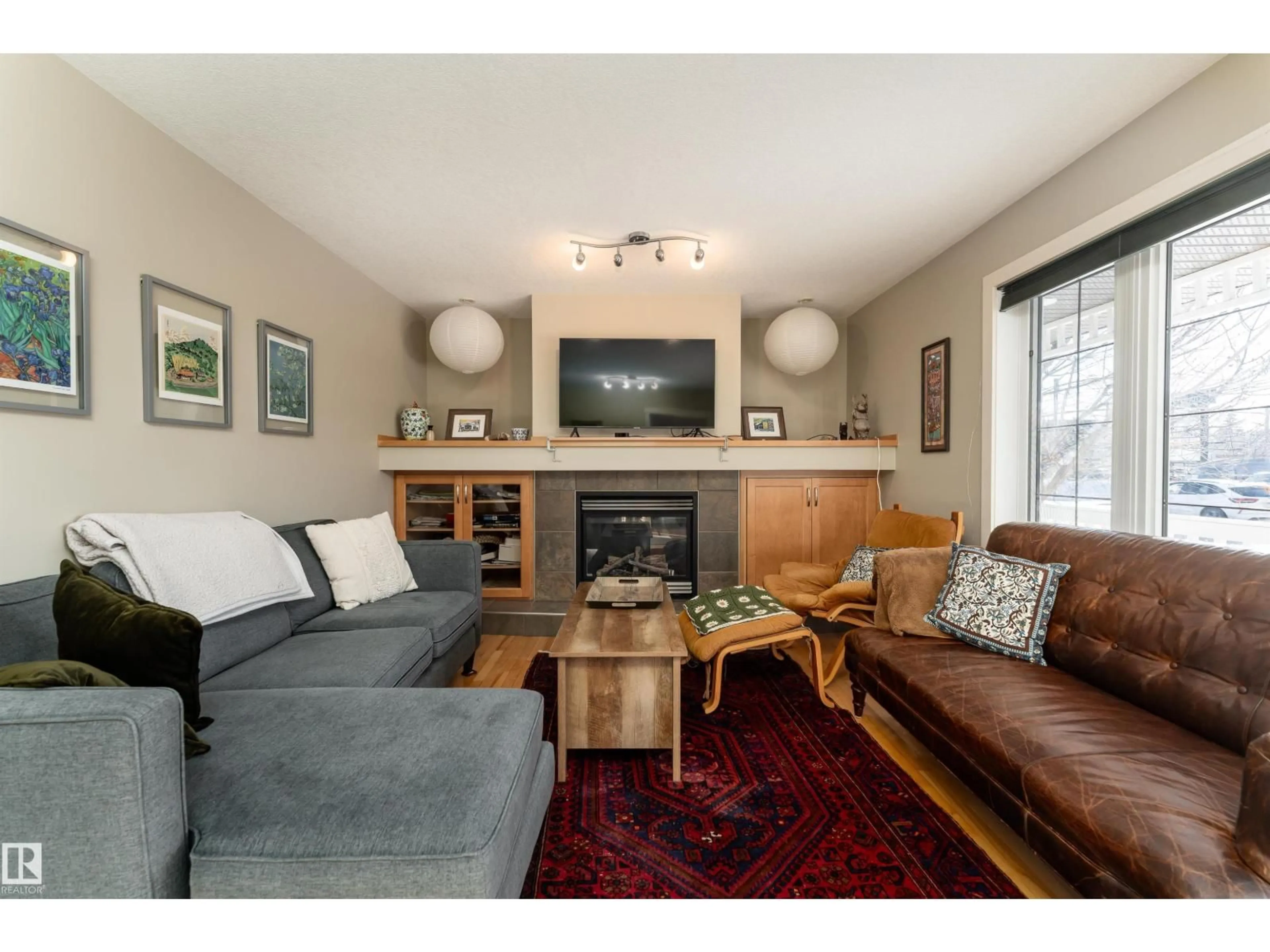 Living room with furniture, wood/laminate floor for 10906 72 AV NW, Edmonton Alberta T6G0A9