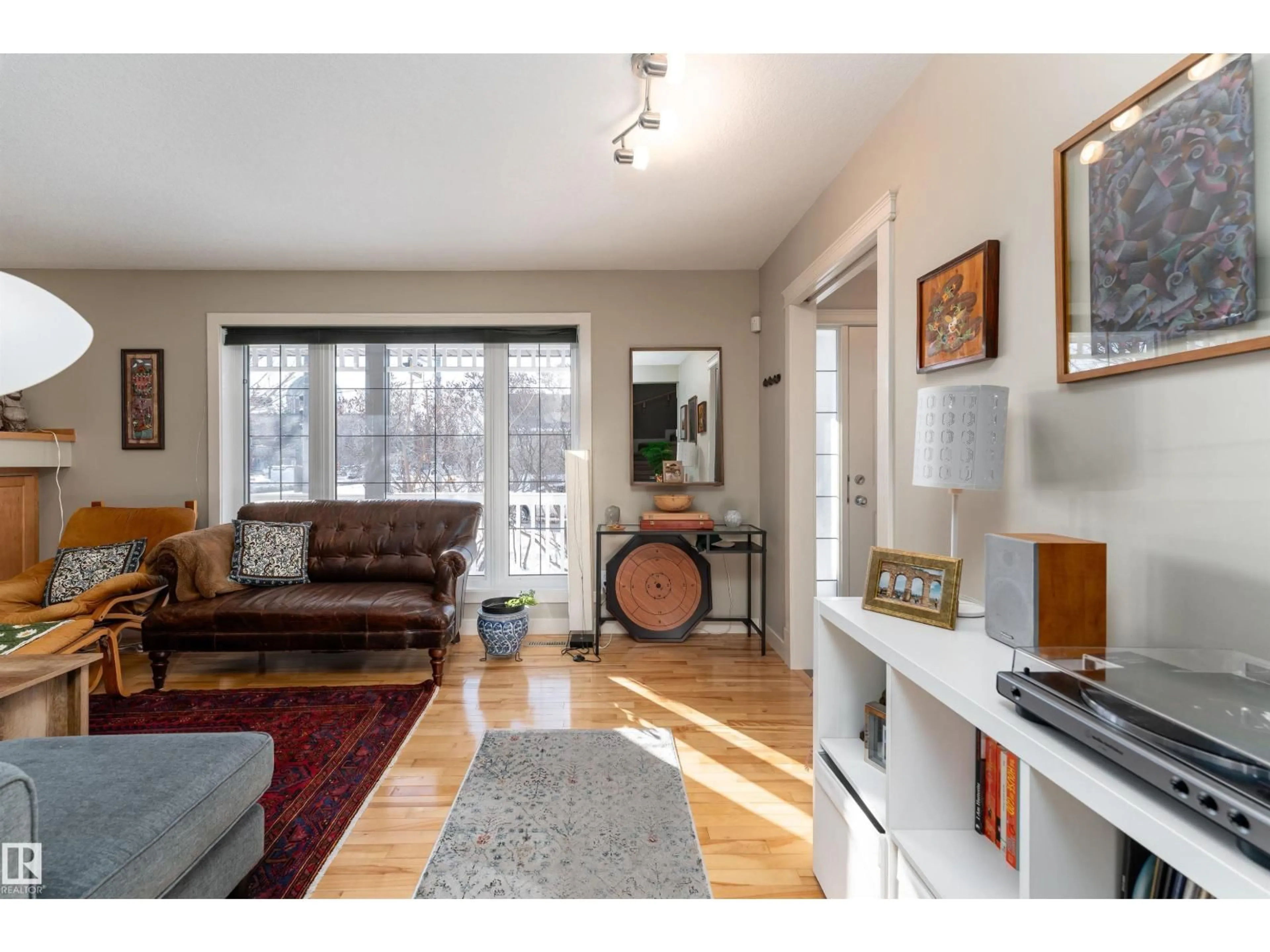 Living room with furniture, wood/laminate floor for 10906 72 AV NW, Edmonton Alberta T6G0A9