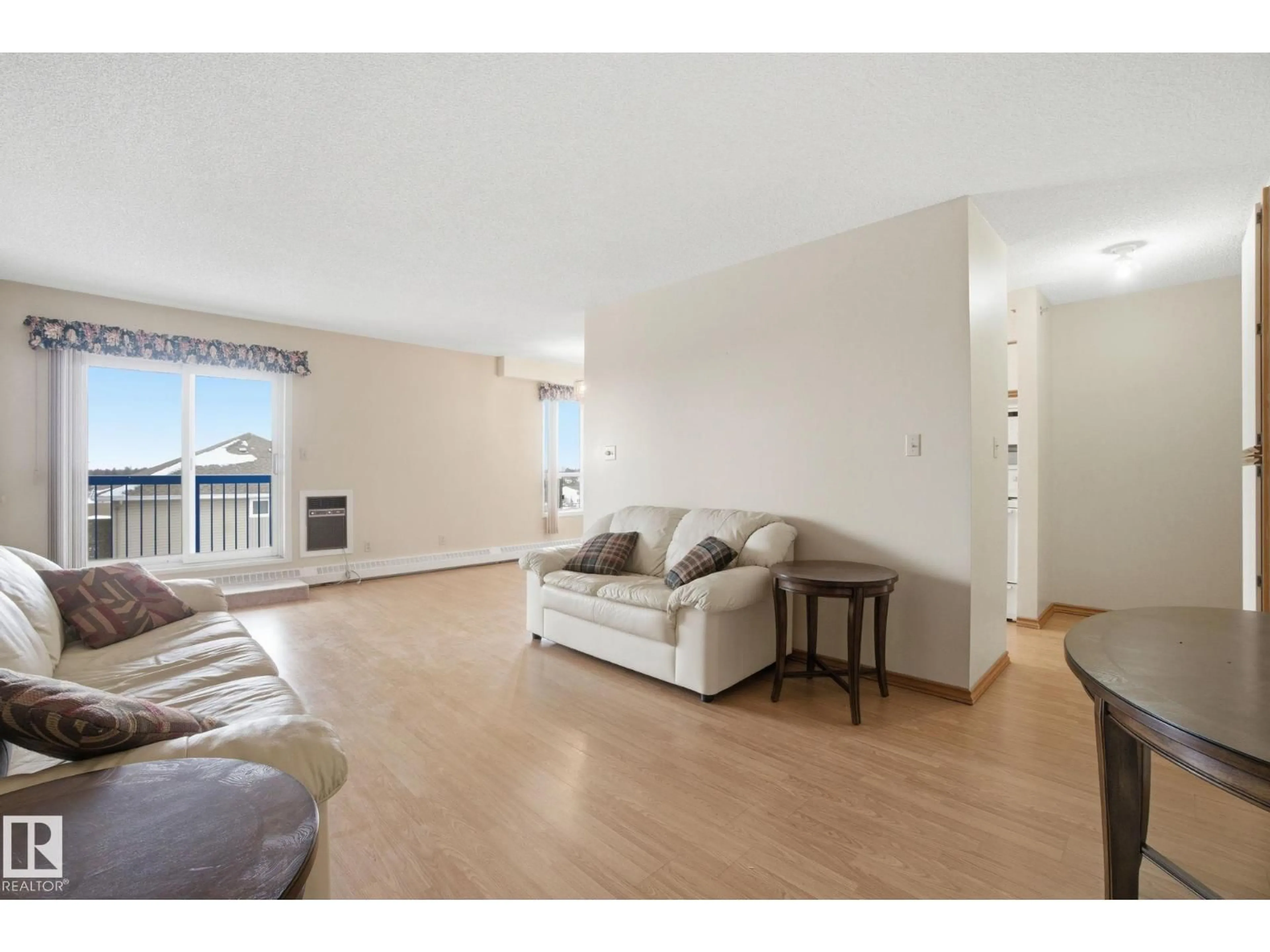 Living room with furniture, wood/laminate floor for 306 - 4812 51 AV, Stony Plain Alberta T7Z1P7