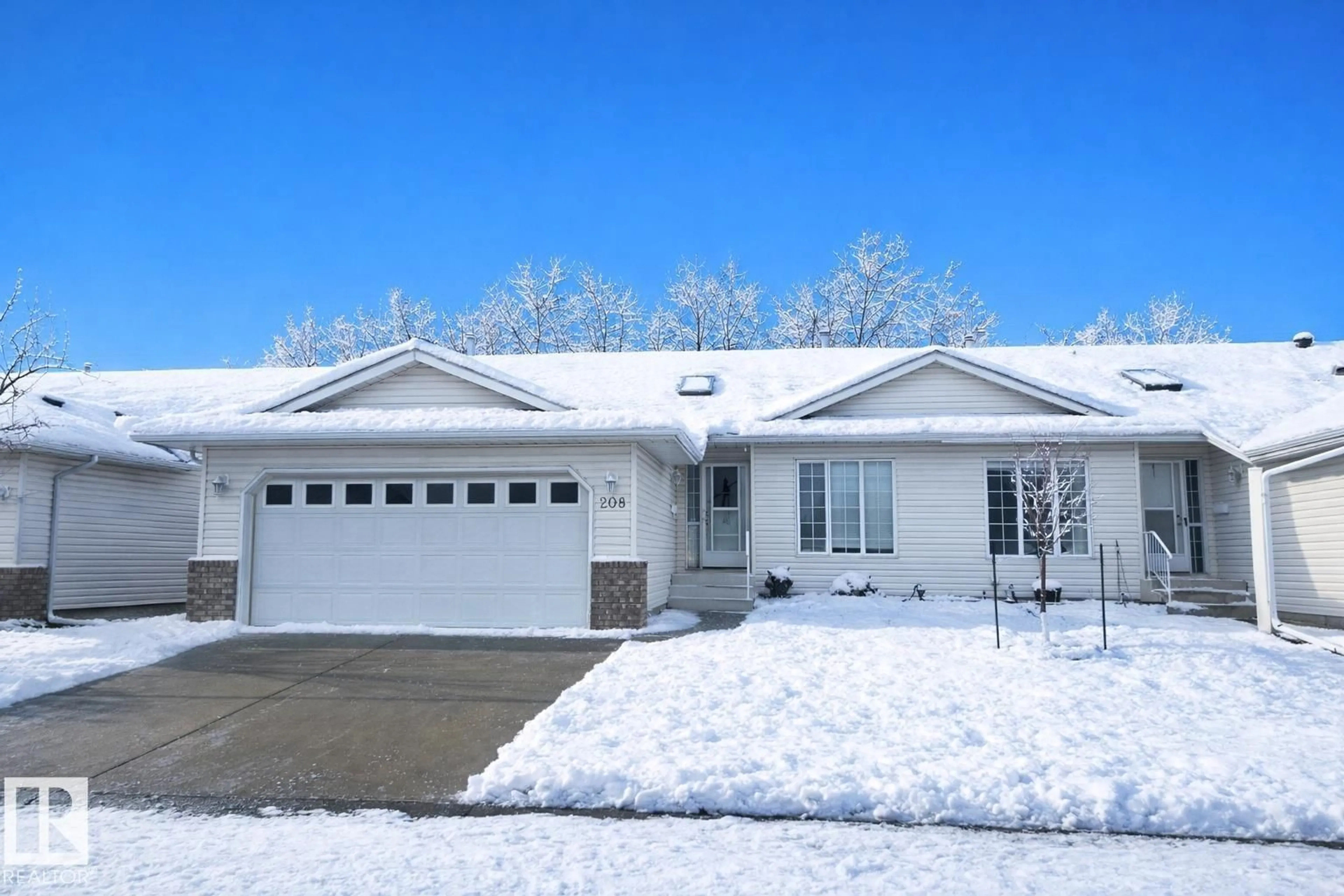 Home with vinyl exterior material, street for 208 RAVINE VI, Leduc Alberta T9E8B9