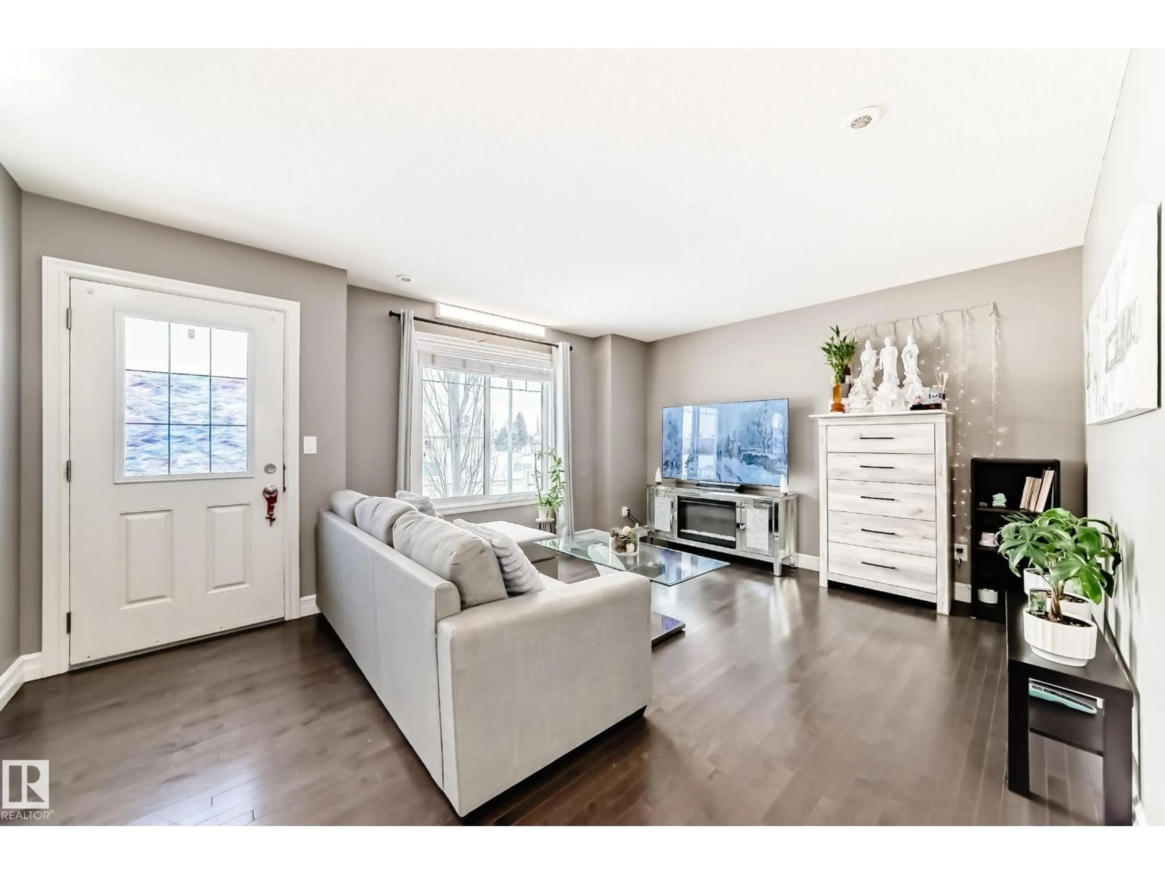 Living room with furniture, wood/laminate floor for 125 3625 144 AV NW, Edmonton Alberta T5Y0T3