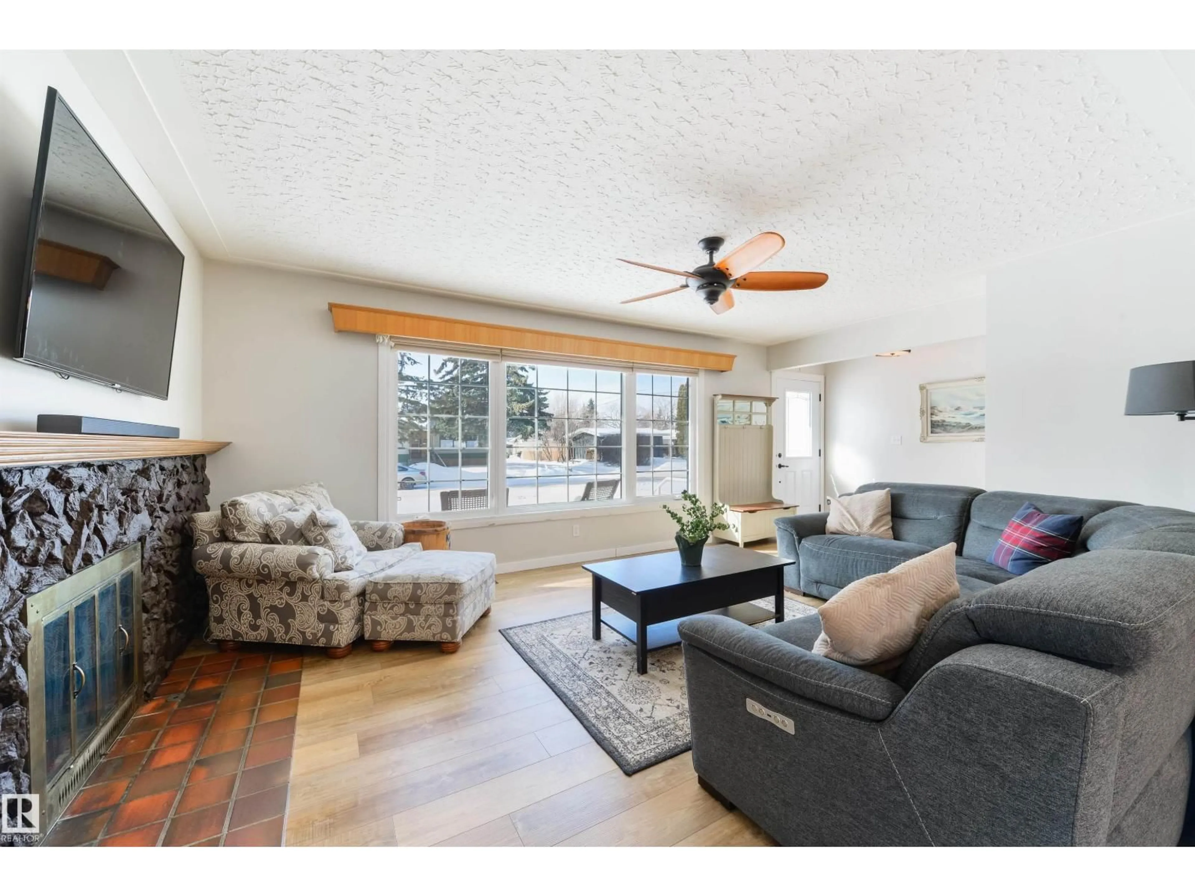 Living room with furniture, wood/laminate floor for NW - 15714 89A AV, Edmonton Alberta T5R4T2
