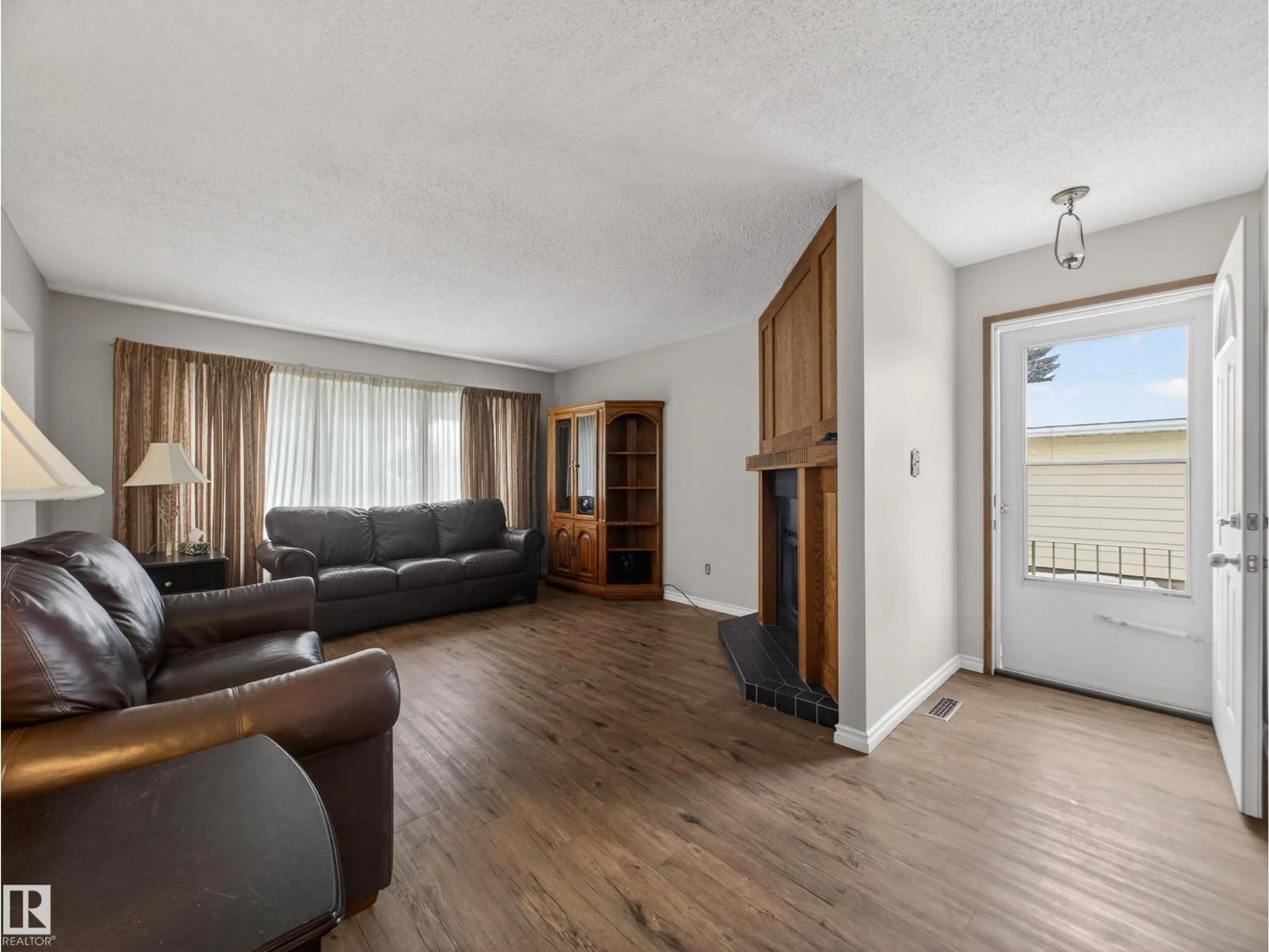 Living room with furniture, wood/laminate floor for 5116 37 AV, Edmonton Alberta T6L1C8