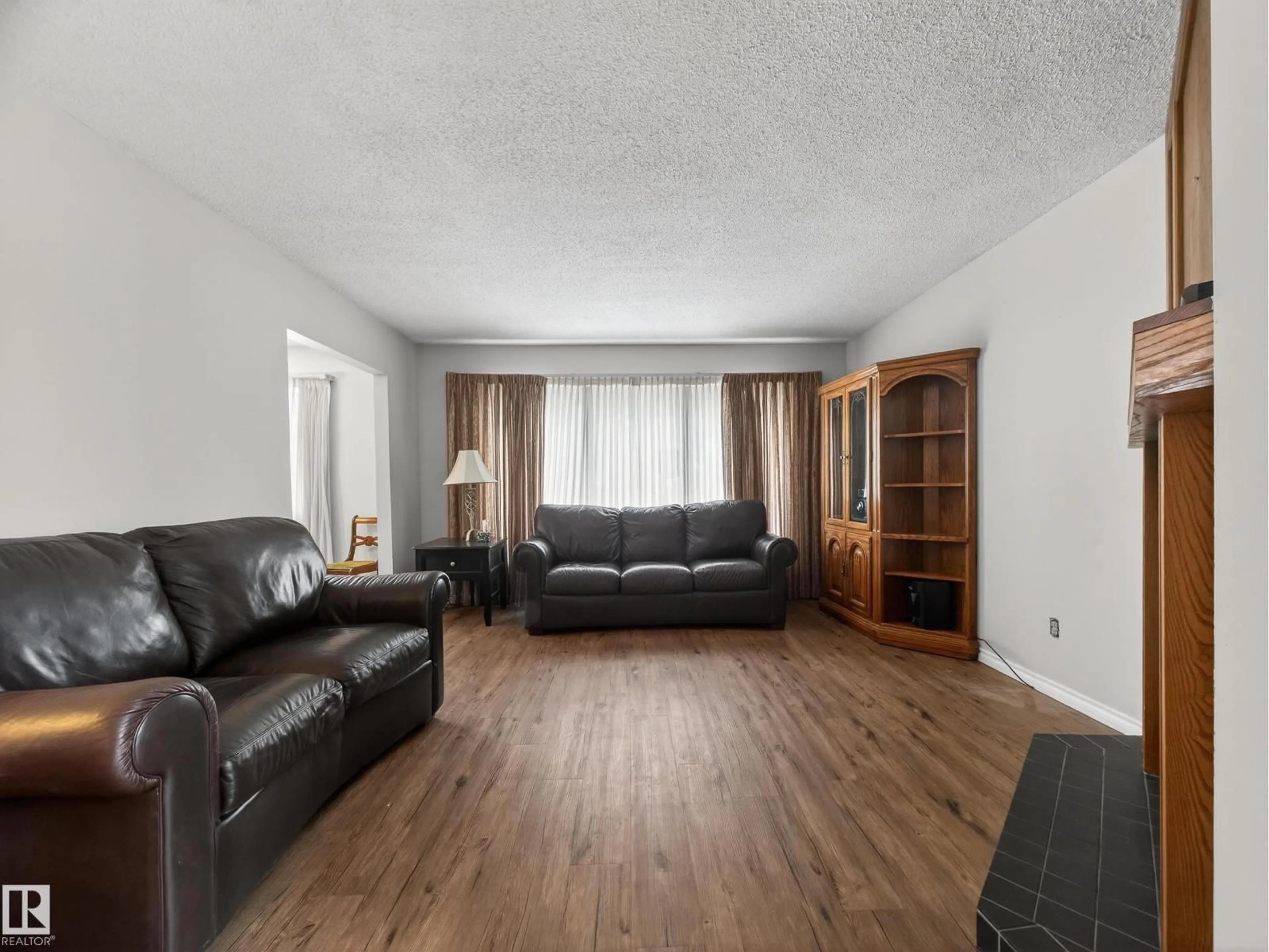 Living room with furniture, wood/laminate floor for 5116 37 AV, Edmonton Alberta T6L1C8