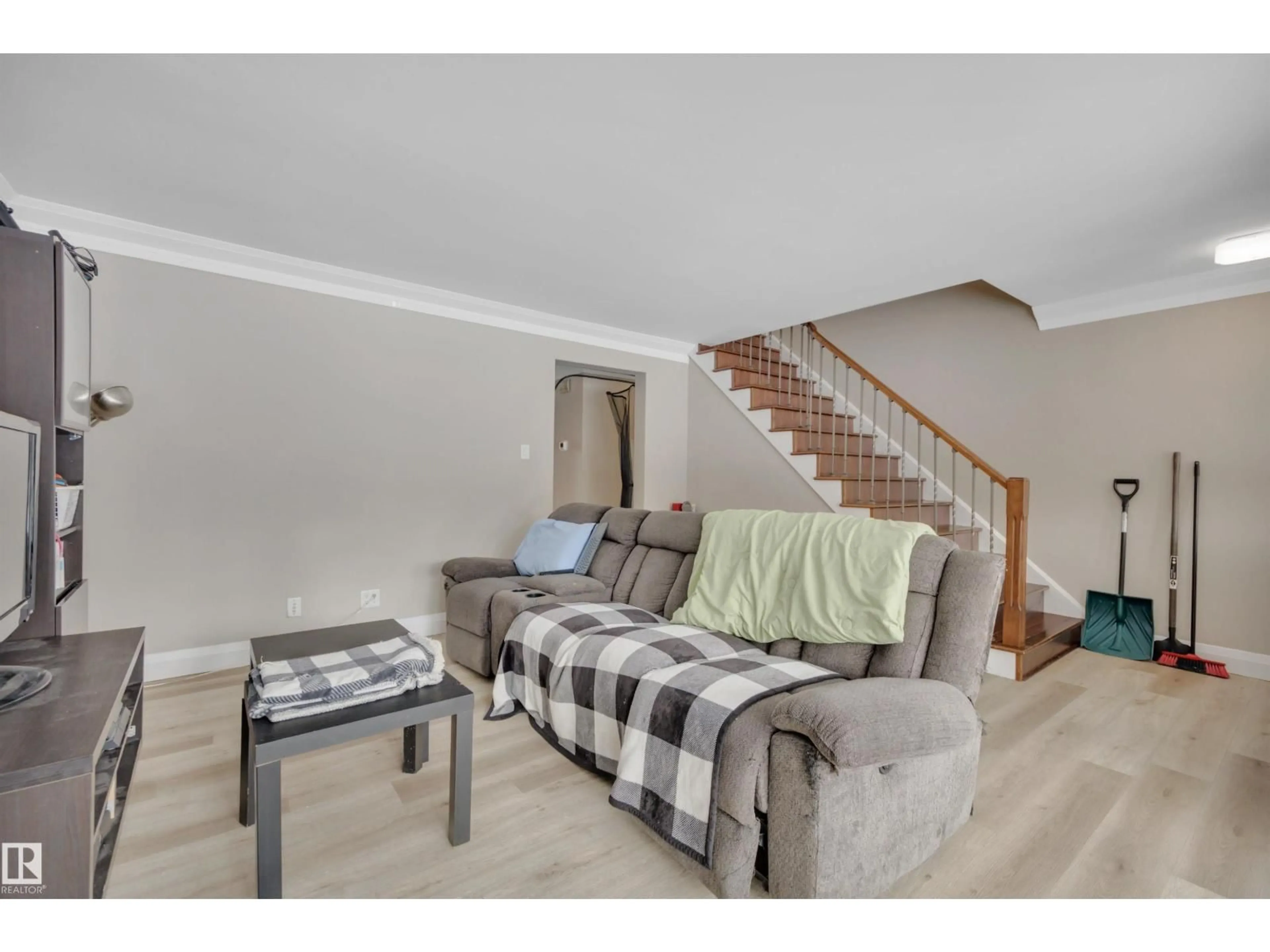 Living room with furniture, wood/laminate floor for 8542 81 AV, Edmonton Alberta T6C0W4