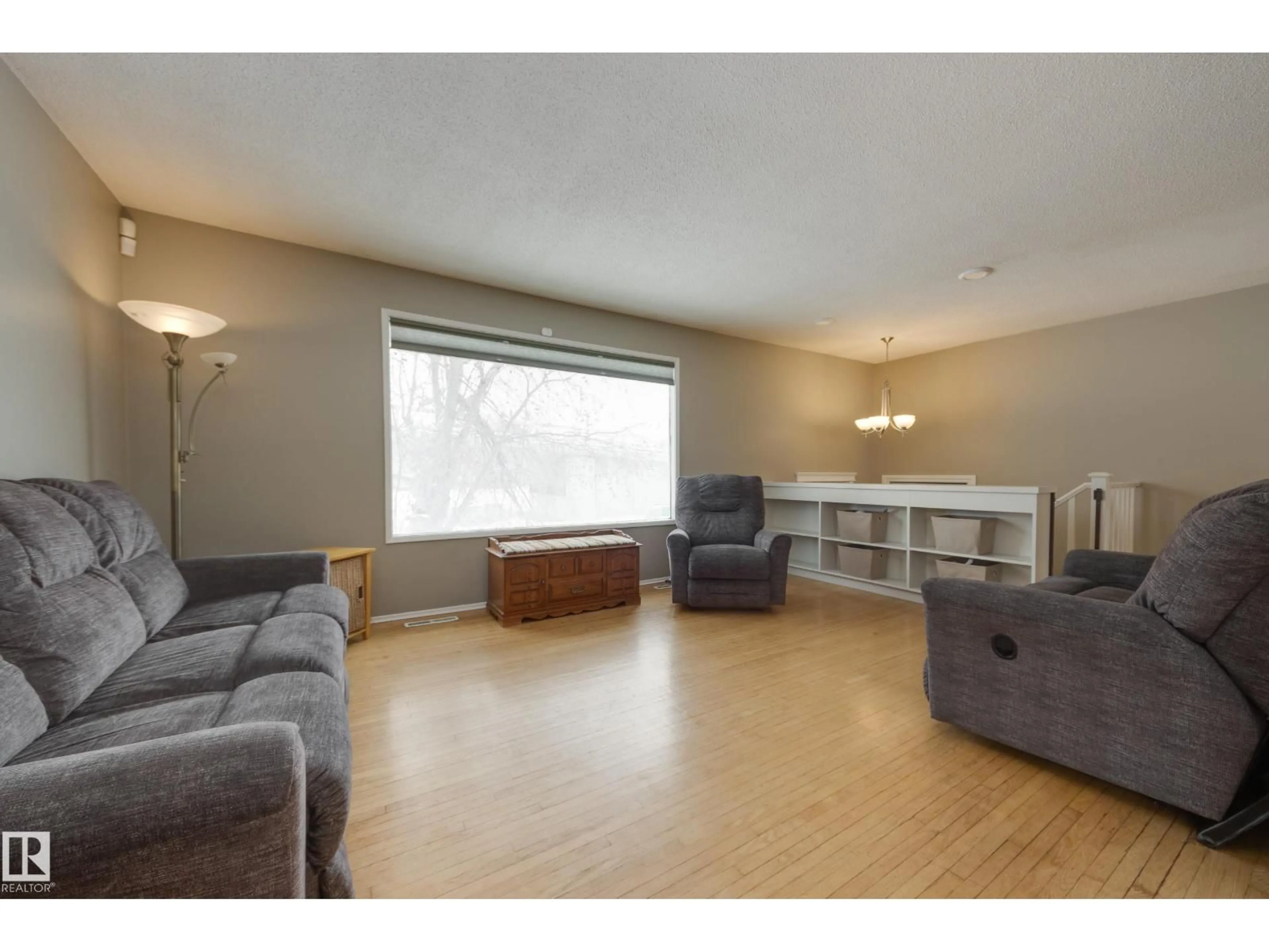 Living room with furniture, wood/laminate floor for 16407 87 AV, Edmonton Alberta T5R4H3