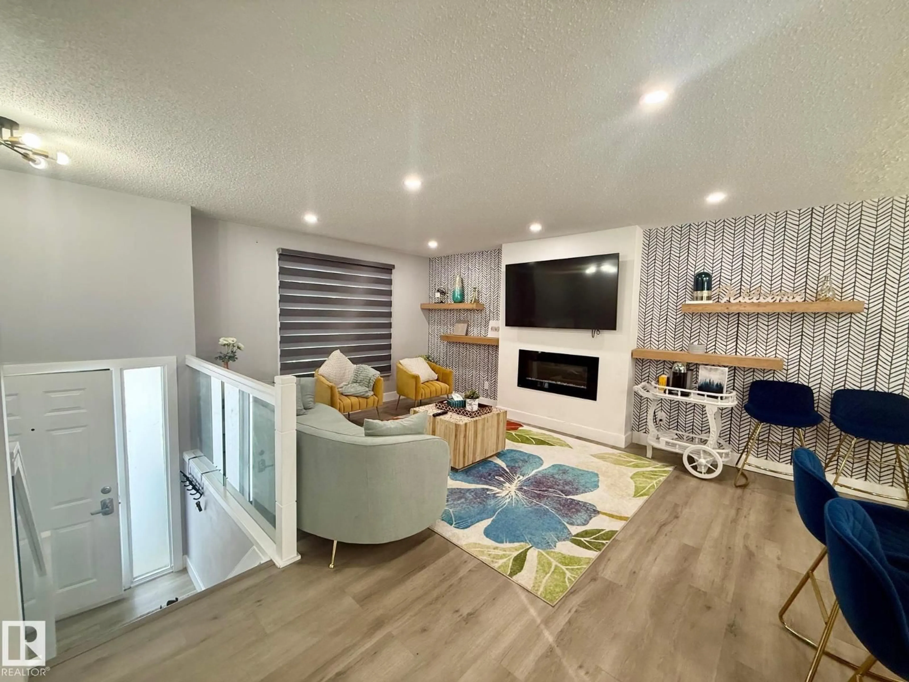 Living room with furniture, wood/laminate floor for 2915 145 AV, Edmonton Alberta T5Y1Z2