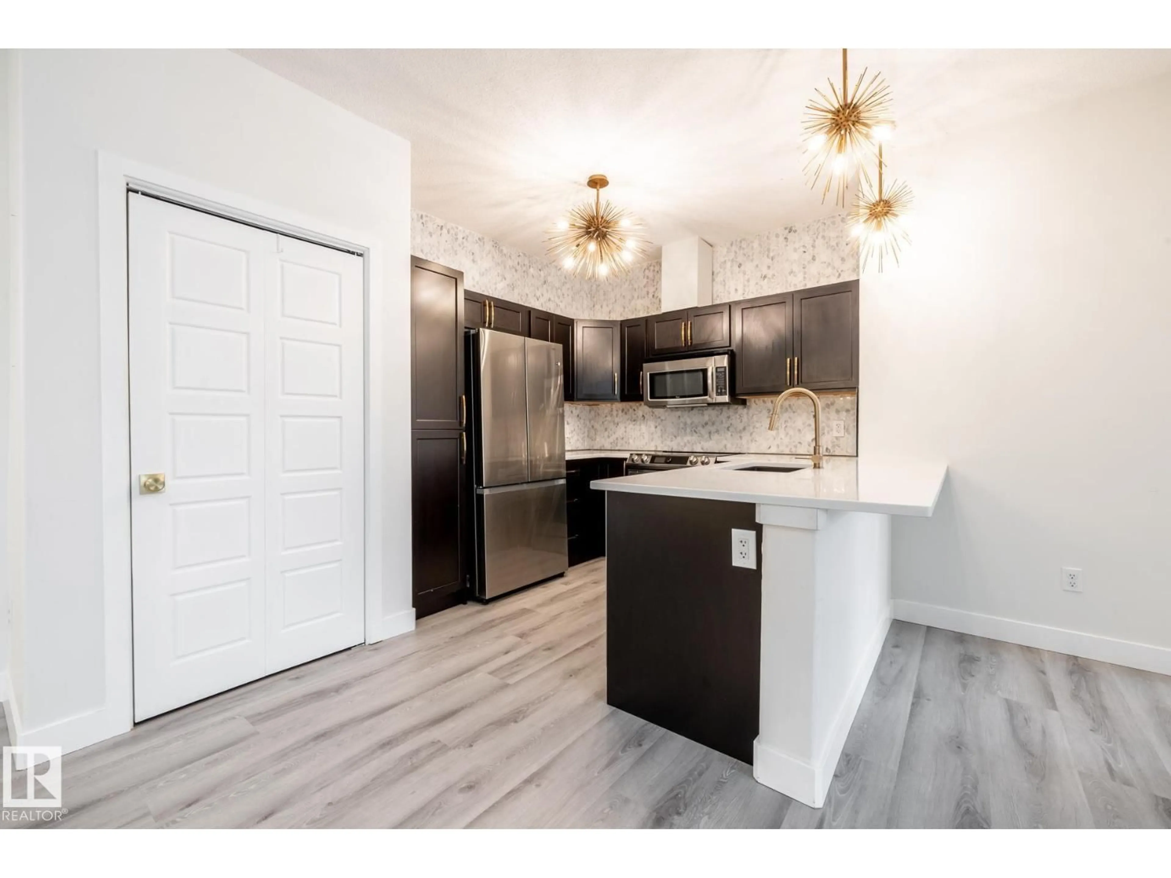 Open concept kitchen, wood/laminate floor for 304 - 105 AMBLESIDE LINK, Edmonton Alberta T6W0V2