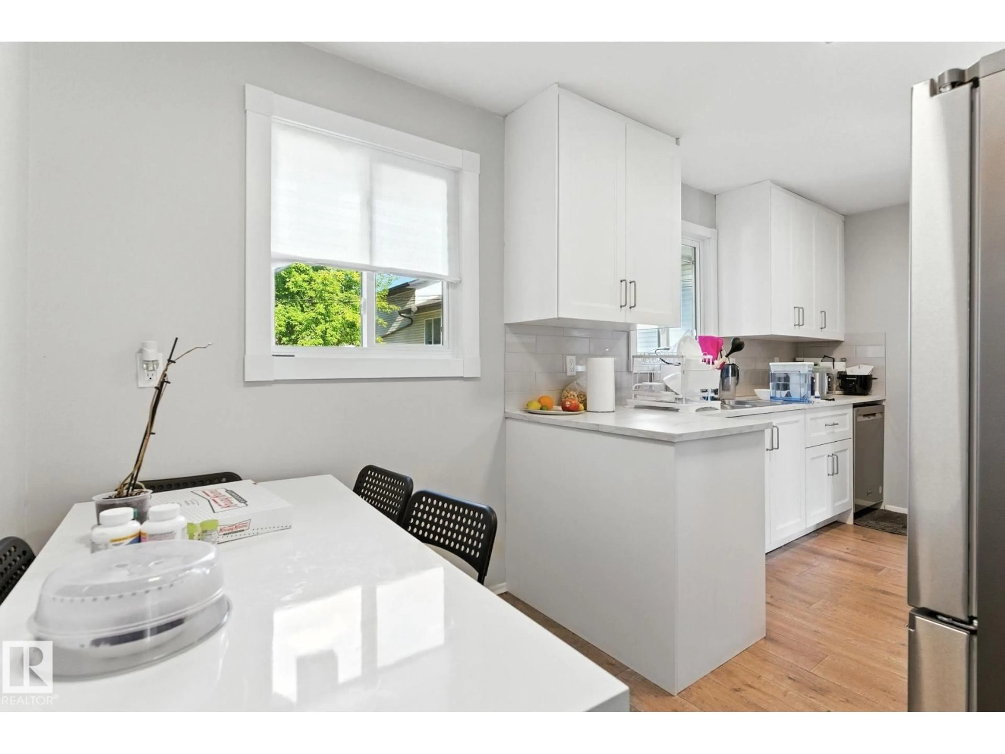 Open concept kitchen, wood/laminate floor for 10505 154 ST, Edmonton Alberta T5P2J1