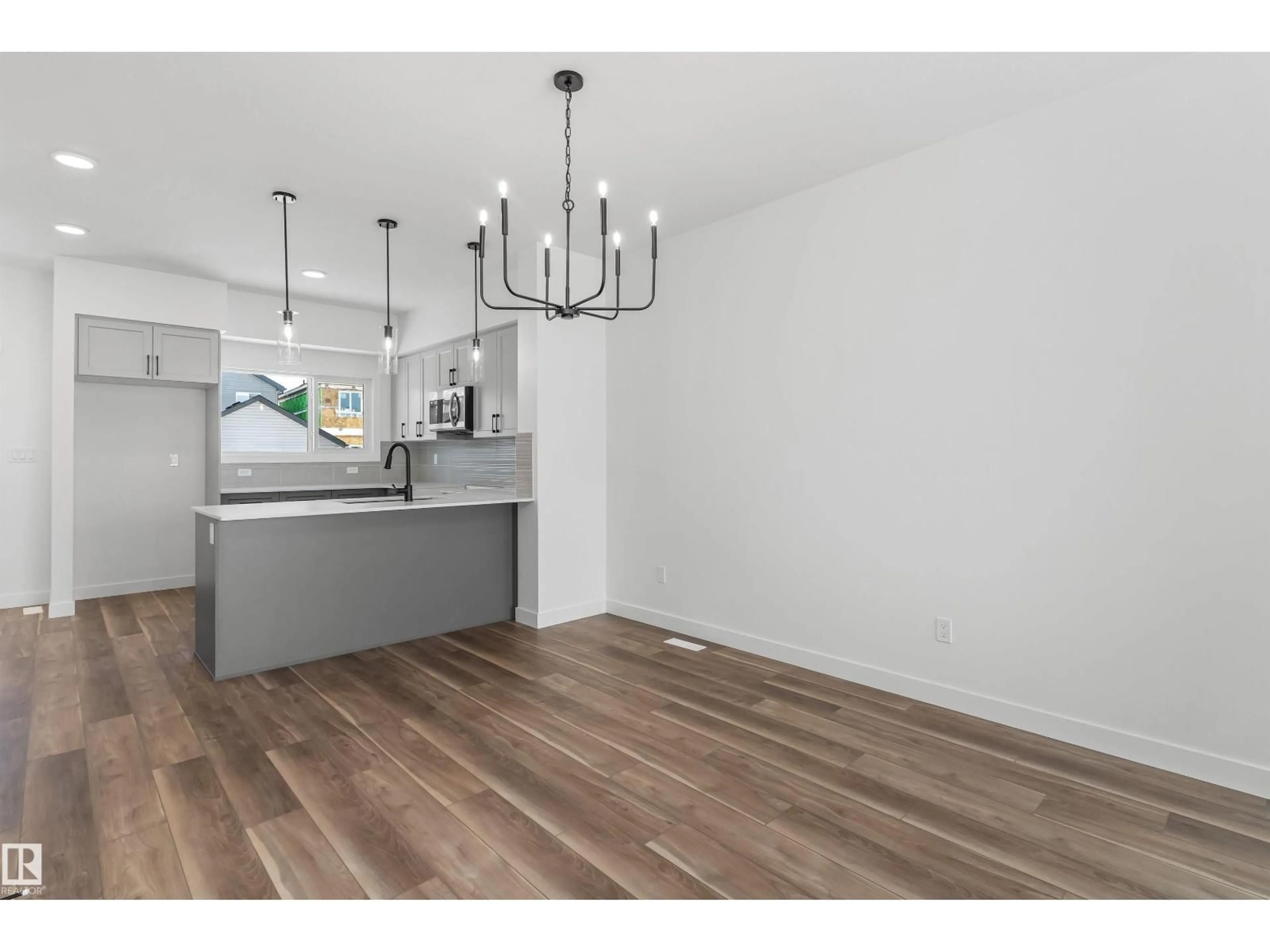 Open concept kitchen, wood/laminate floor for 1008 14 AV, Edmonton Alberta T6T2W7