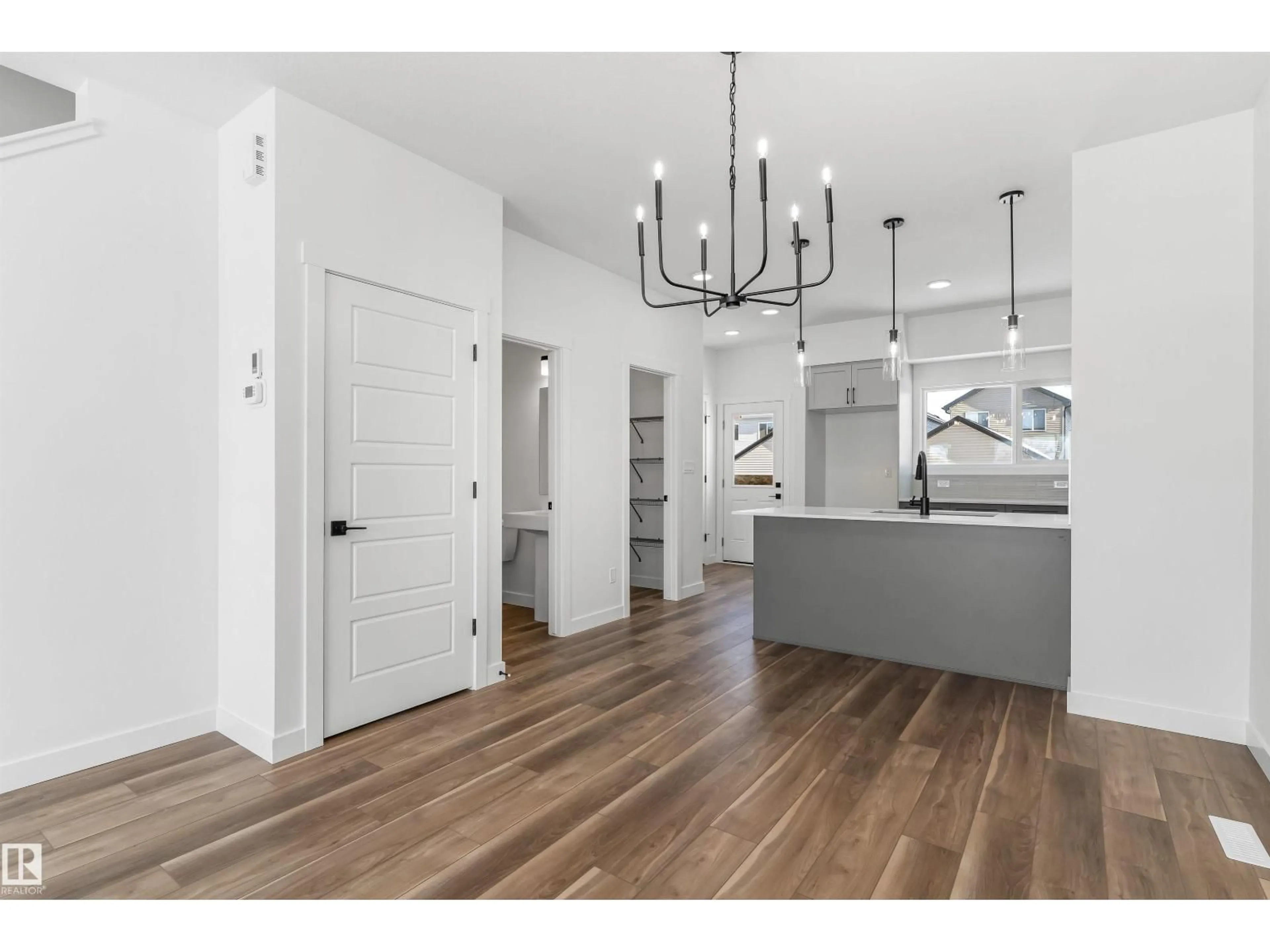 Open concept kitchen, wood/laminate floor for 1008 14 AV, Edmonton Alberta T6T2W7