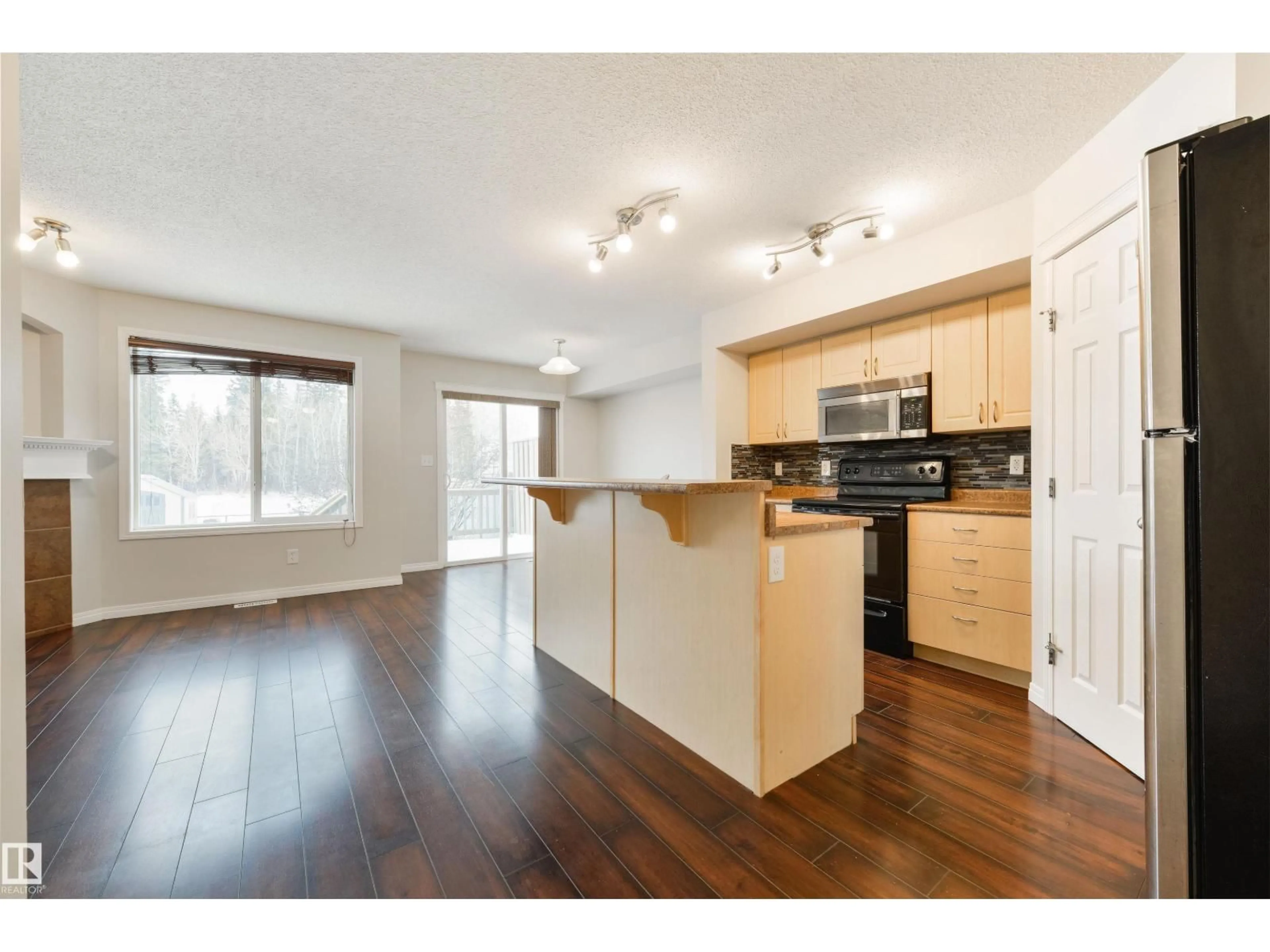 Open concept kitchen, wood/laminate floor for 114 HARTWICK LO, Spruce Grove Alberta T7X0A5