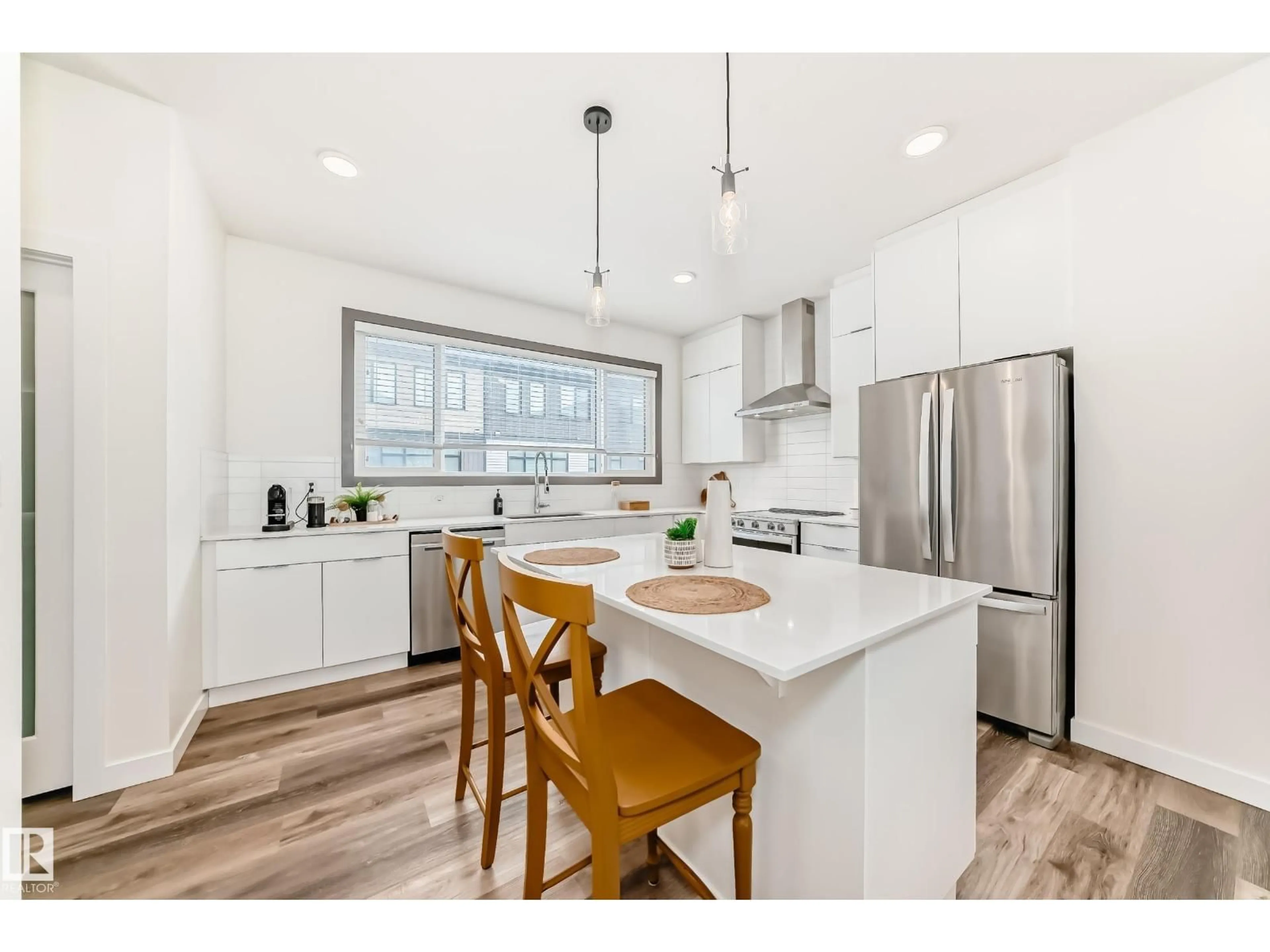 Open concept kitchen, wood/laminate floor for #102 - 50 EBONY BV, Sherwood Park Alberta T8H1X8