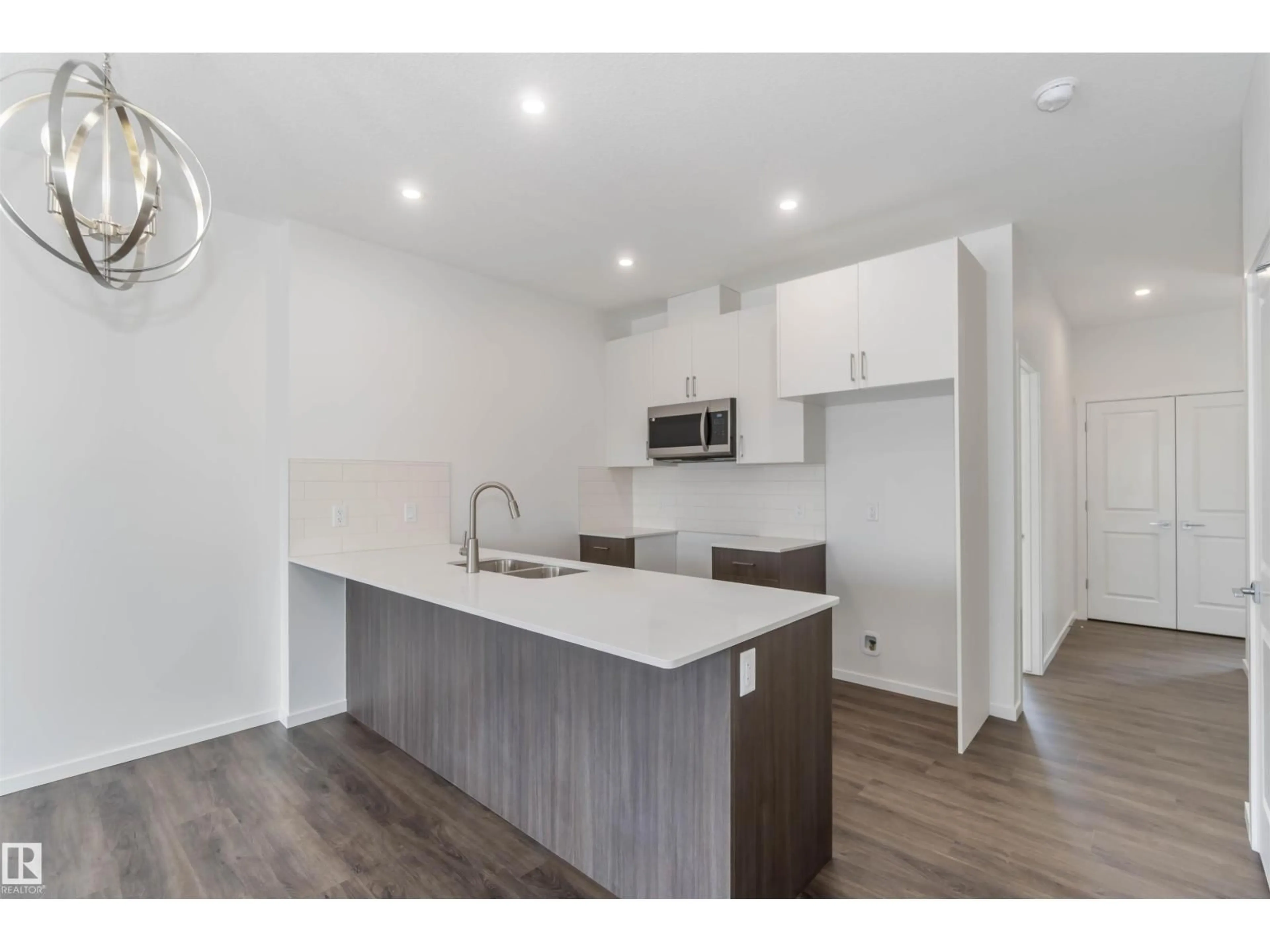 Open concept kitchen, wood/laminate floor for NW - 2467 ALCES LINK LI, Edmonton Alberta T6M3B1