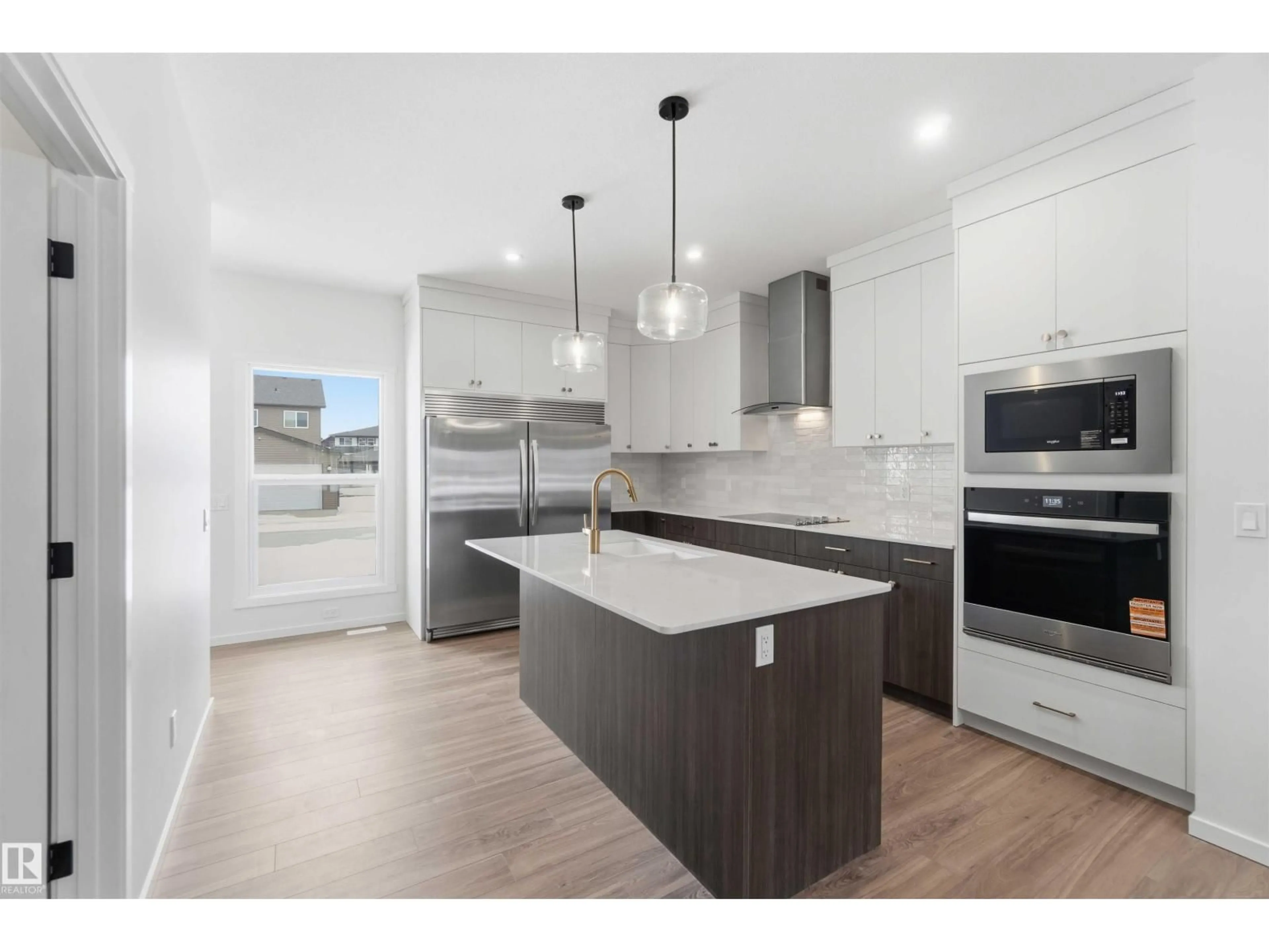 Open concept kitchen, wood/laminate floor for SW SW - 5735 HAWTHORN CM, Edmonton Alberta T6X3K8