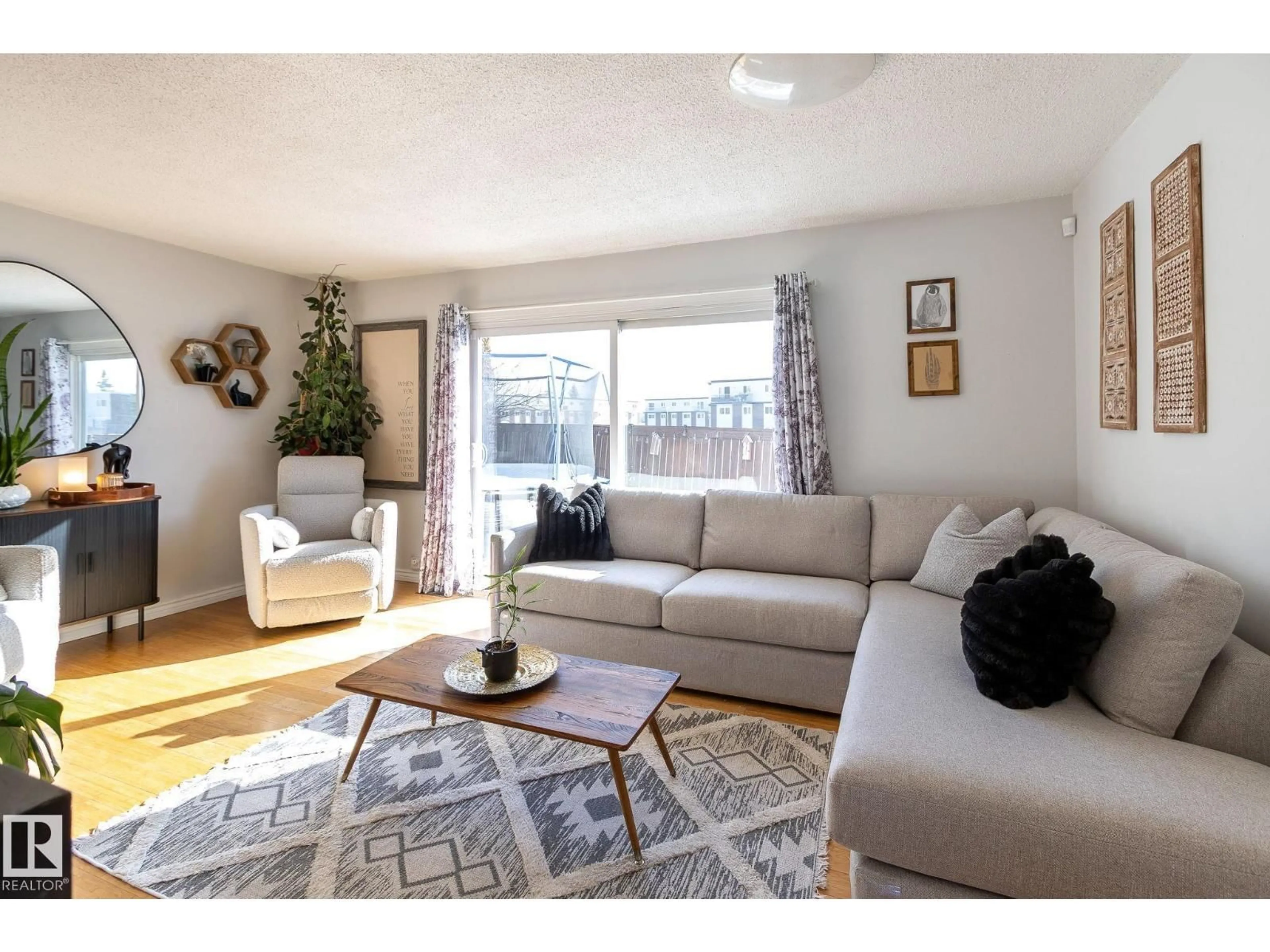Living room with furniture, wood/laminate floor for NW - 3859 85 ST, Edmonton Alberta T6K2L5