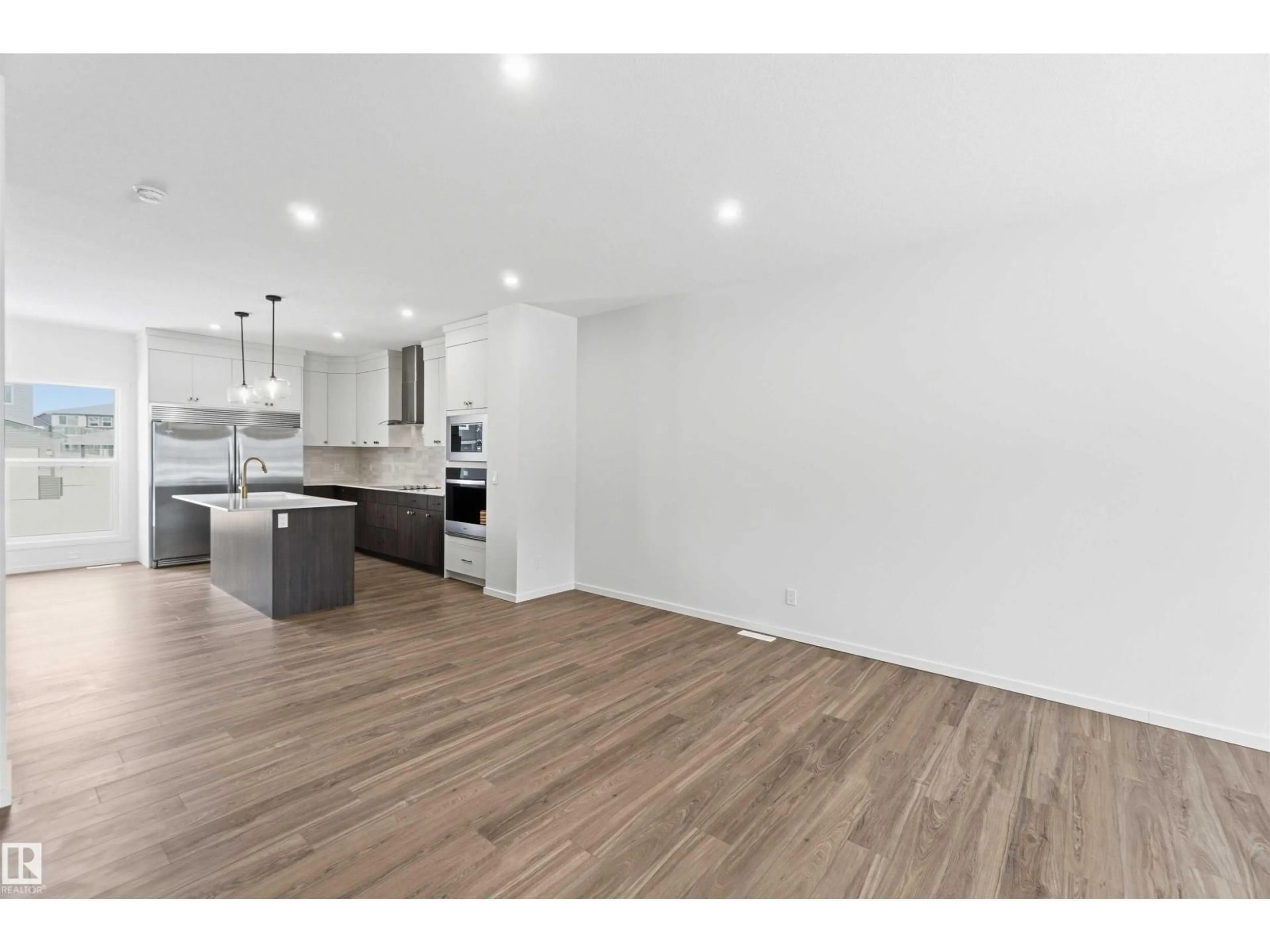 Open concept kitchen, wood/laminate floor for 19348 29 AV, Edmonton Alberta T6M3B1